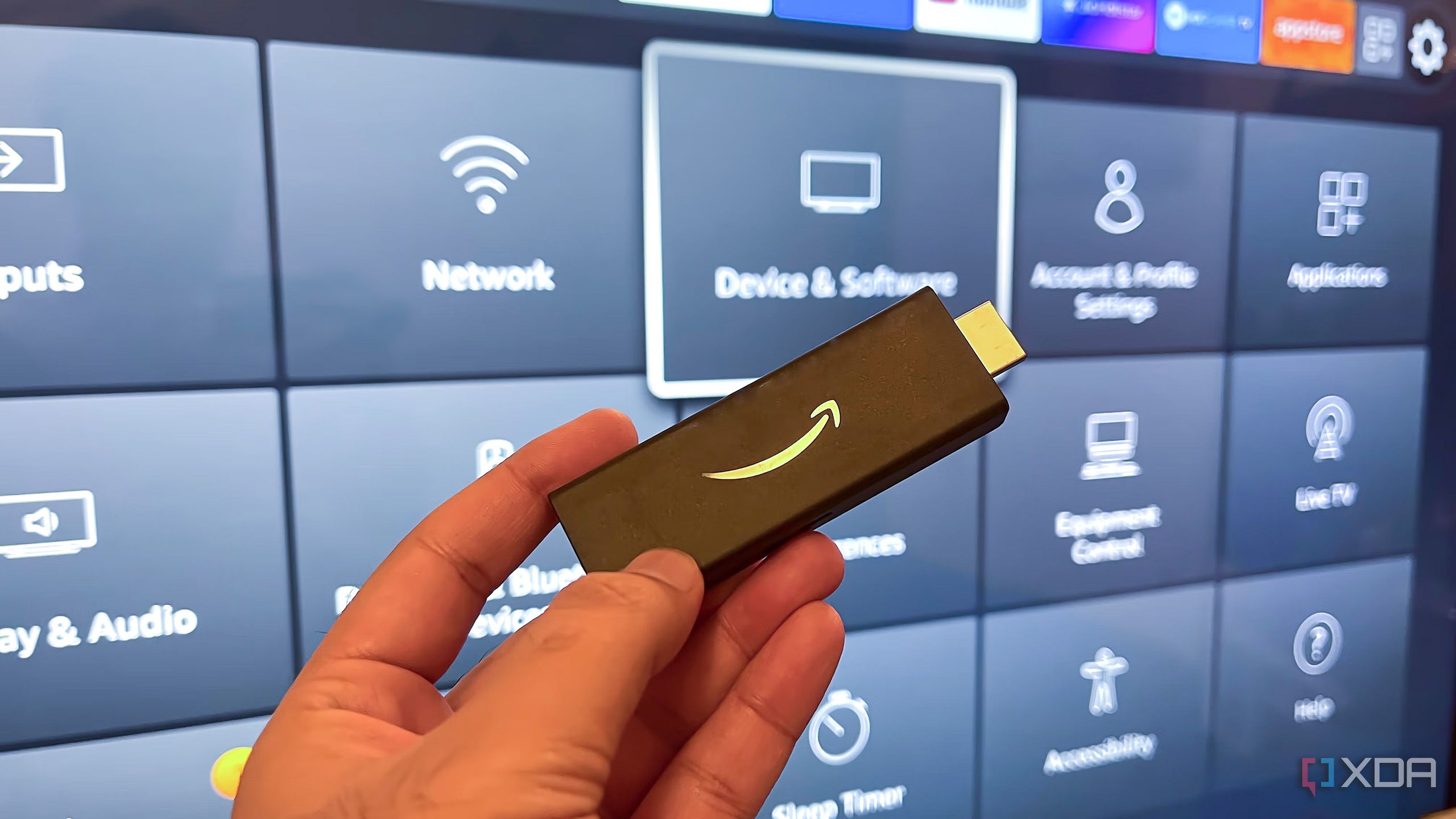 A Fire TV Stick in front of a TV