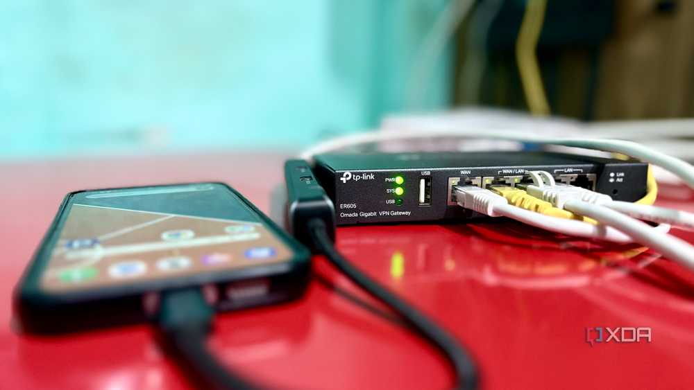 Galaxy phone connected via a USB-C to Ethernet adapter, cable running into a spare WAN port on a TP-Link ER605 router