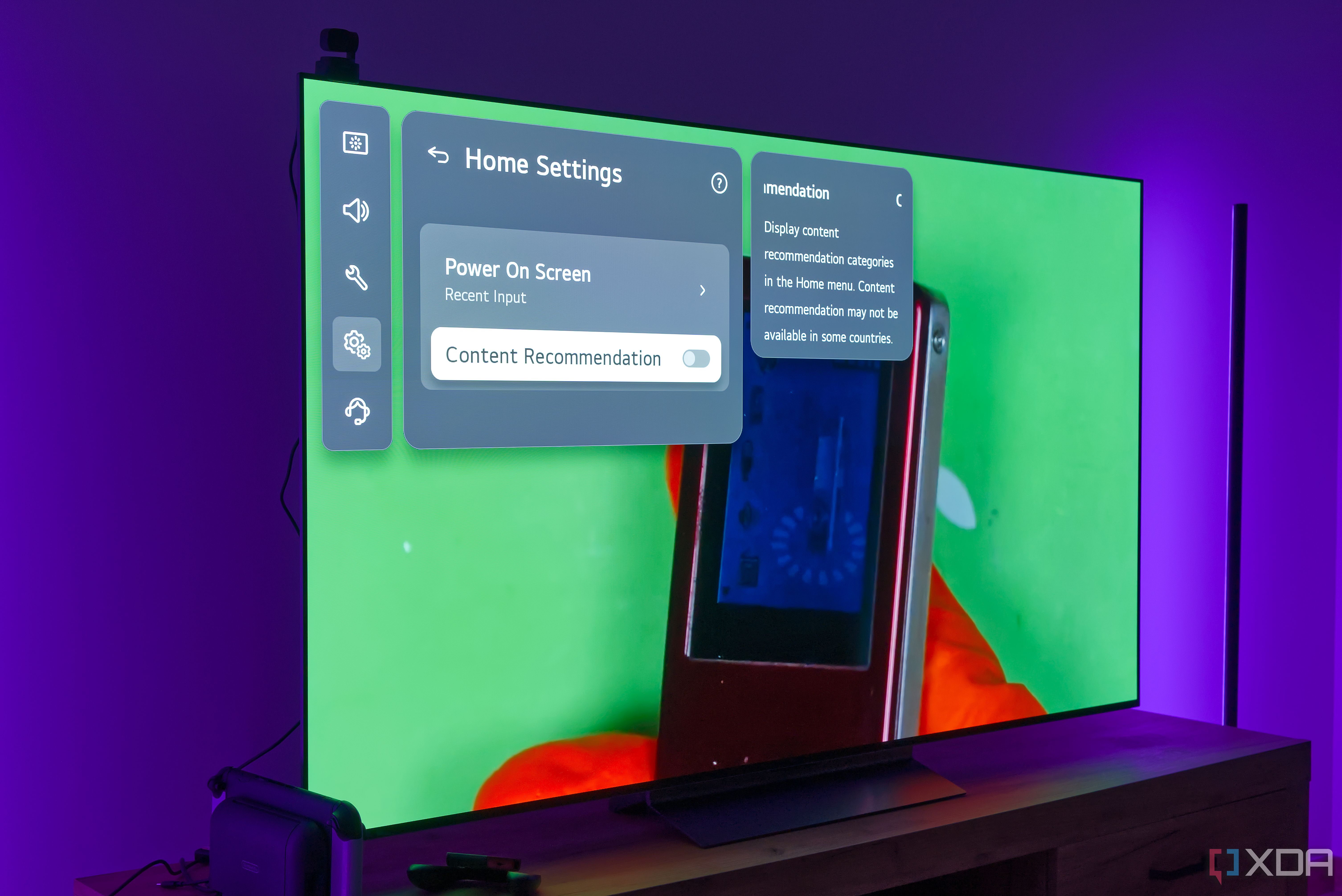 An LG TV showing options for customizing the Home screen with content recommendations turned off, with a background showing an MP3 player over a green surface