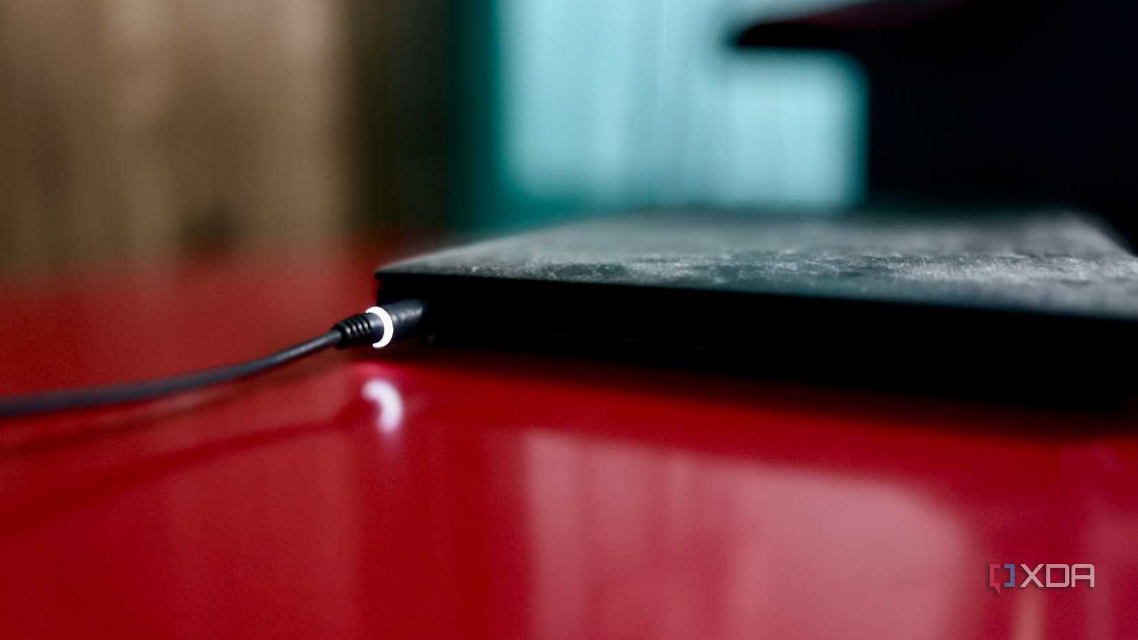 Charging cable plugged into a laptop, representing its built-in battery backup