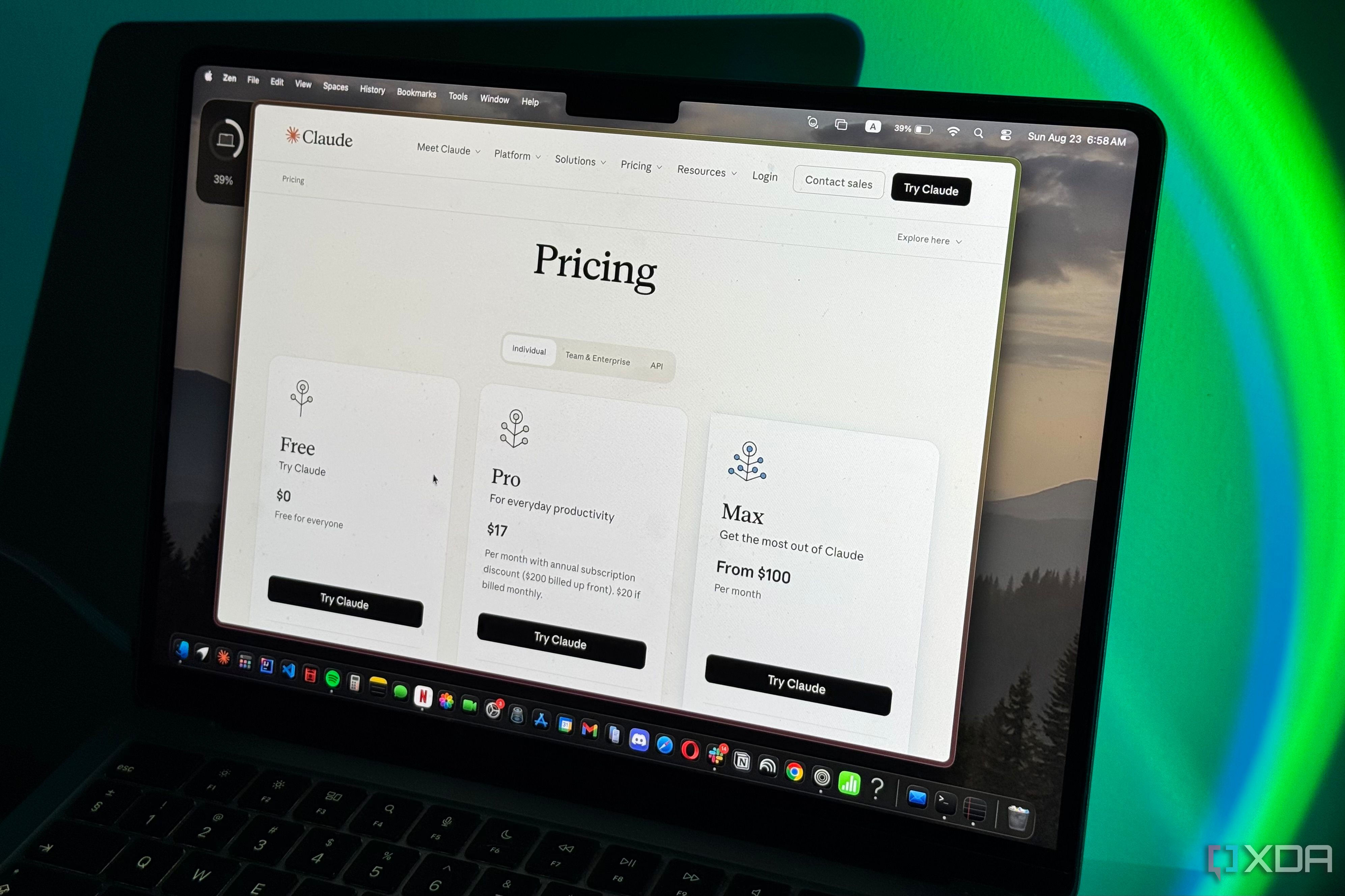 Laptop screen showing Claude's pricing page with Free, Pro, and Max plans