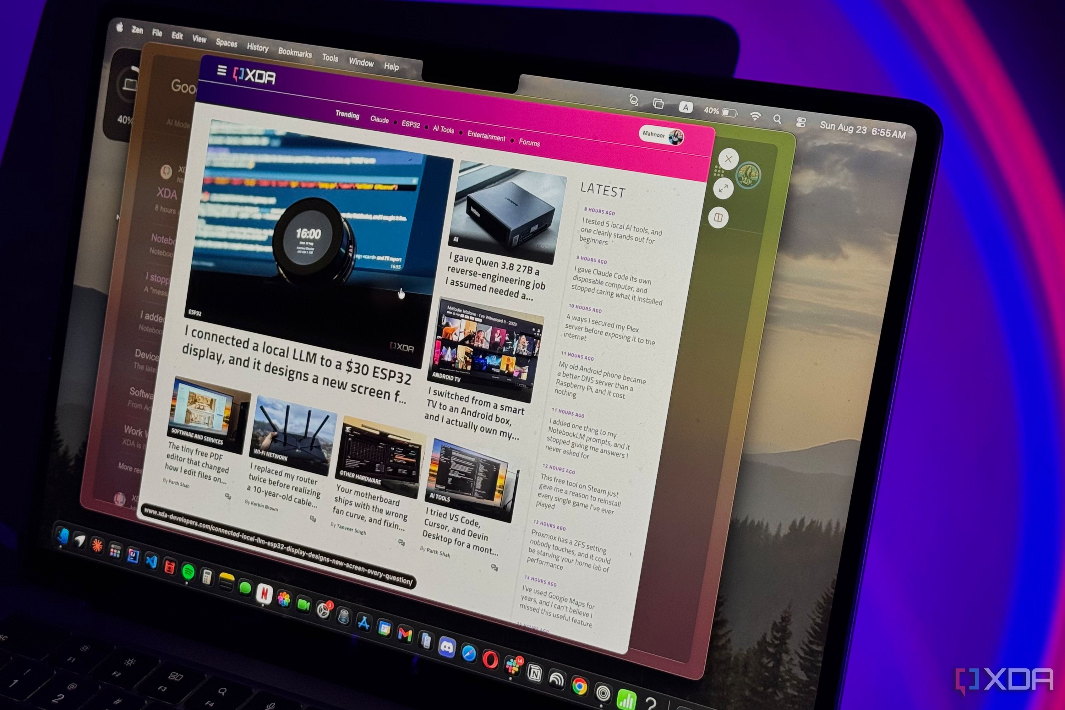 Laptop screen showing XDA Developers homepage with tech articles in Zen Browser