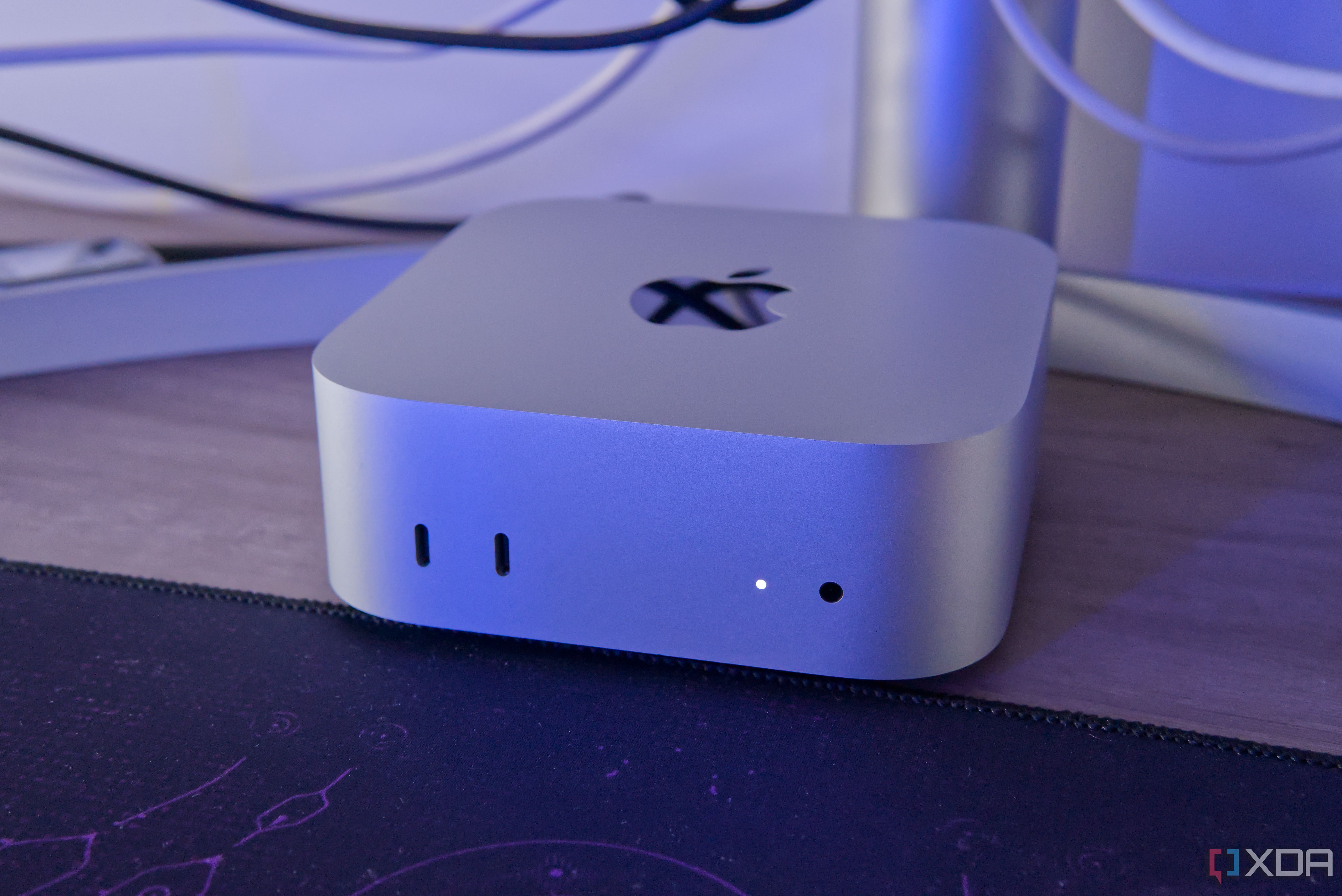 Close-up of a Mac Mini in front of a monitor stand