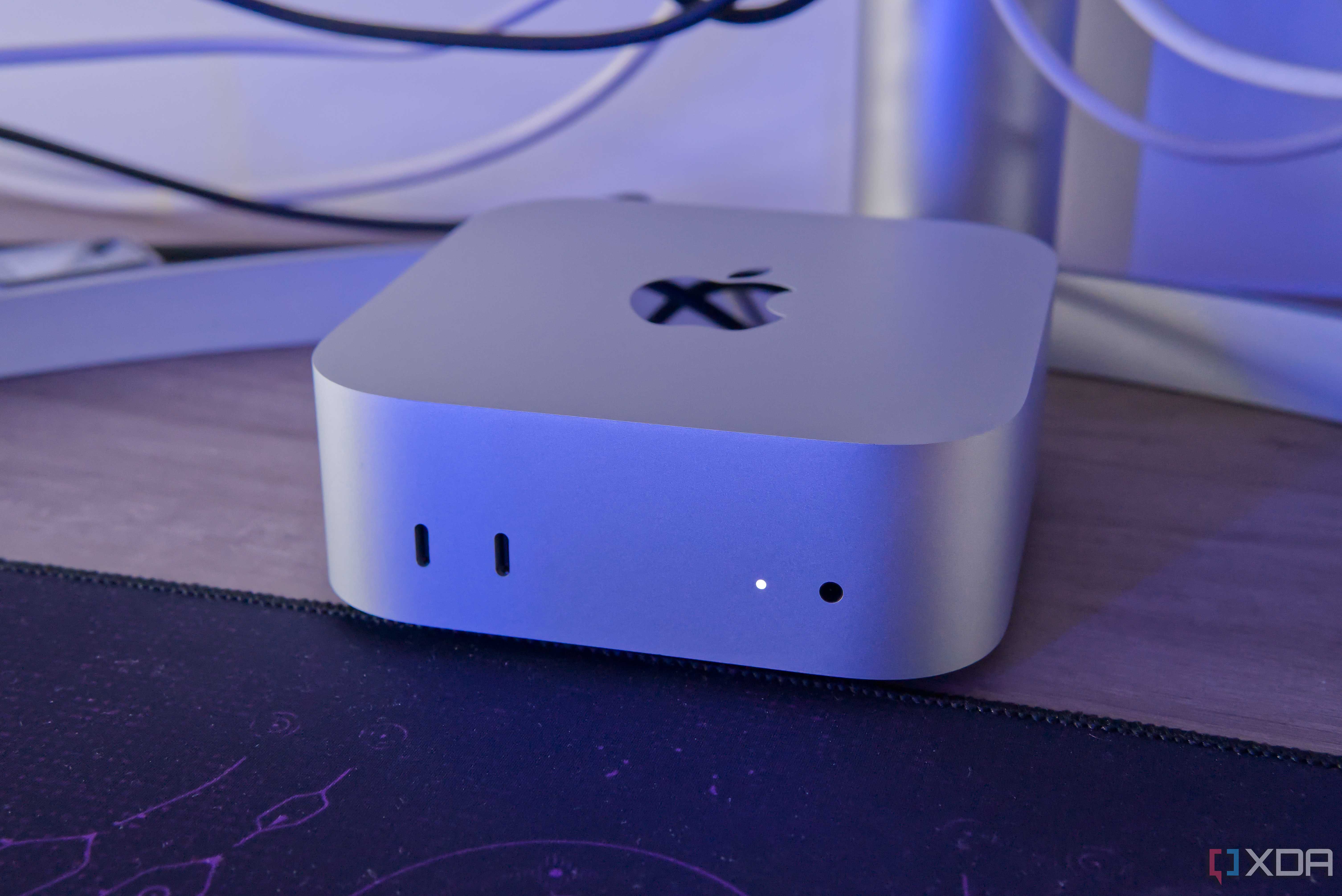 Close-up of a Mac Mini in front of a monitor stand