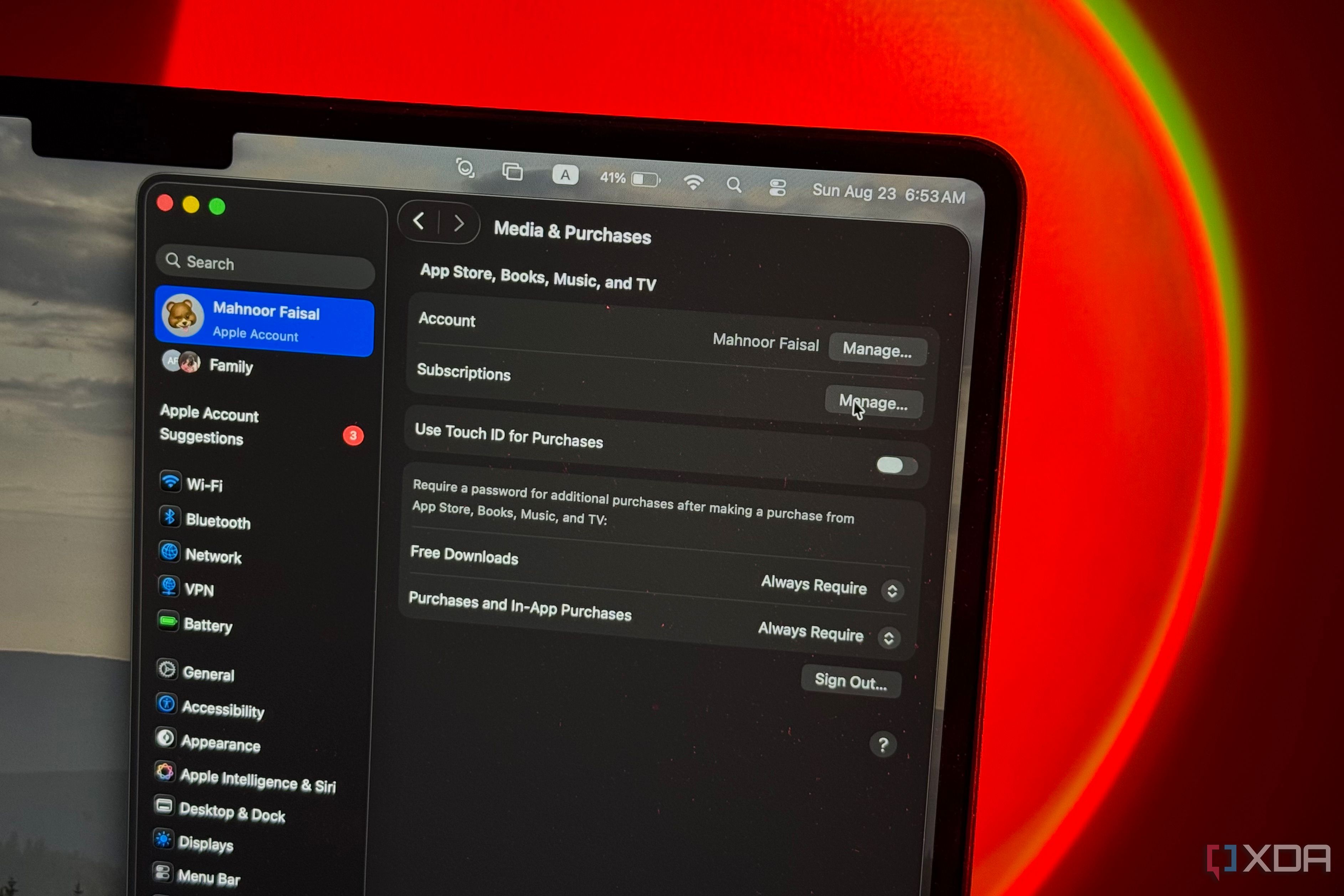 MacBook screen showing macOS Media & Purchases settings under Mahnoor Faisal's Apple Account