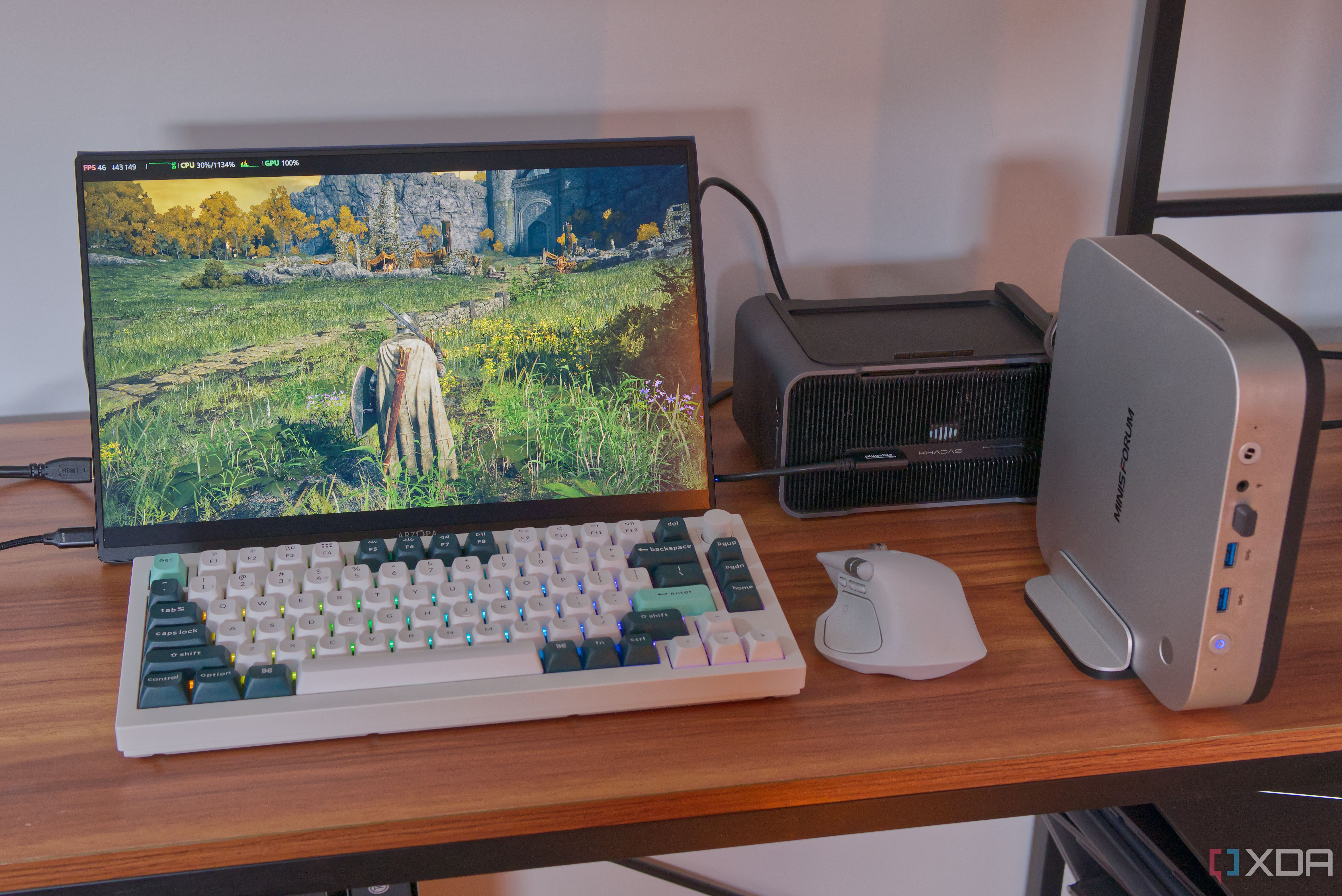A mini PC with an external GPU, portable display, and a keyboard