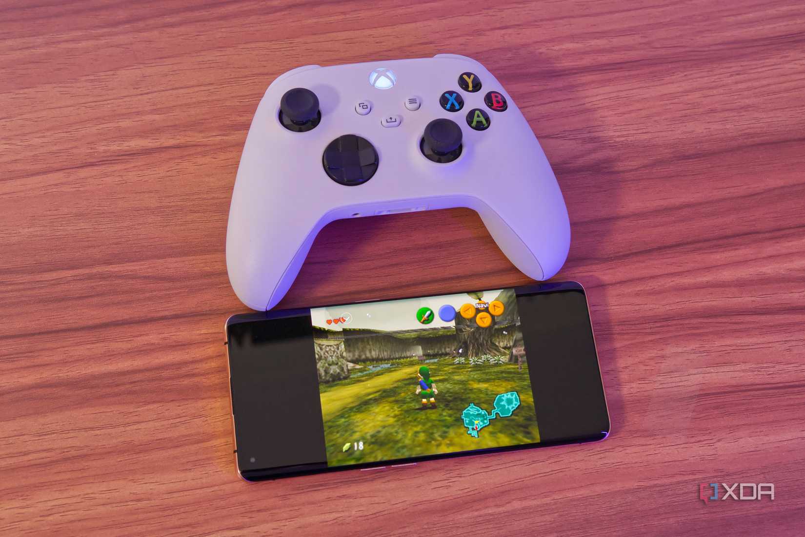 A phone running Time of Zelda Ocarina in RetroArch with an Xbox wireless controller on top