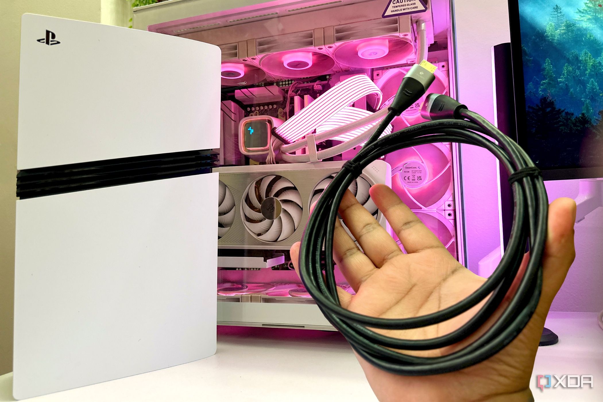 A PS5 Pro with a gaming PC along with an HDMI cable bundle.