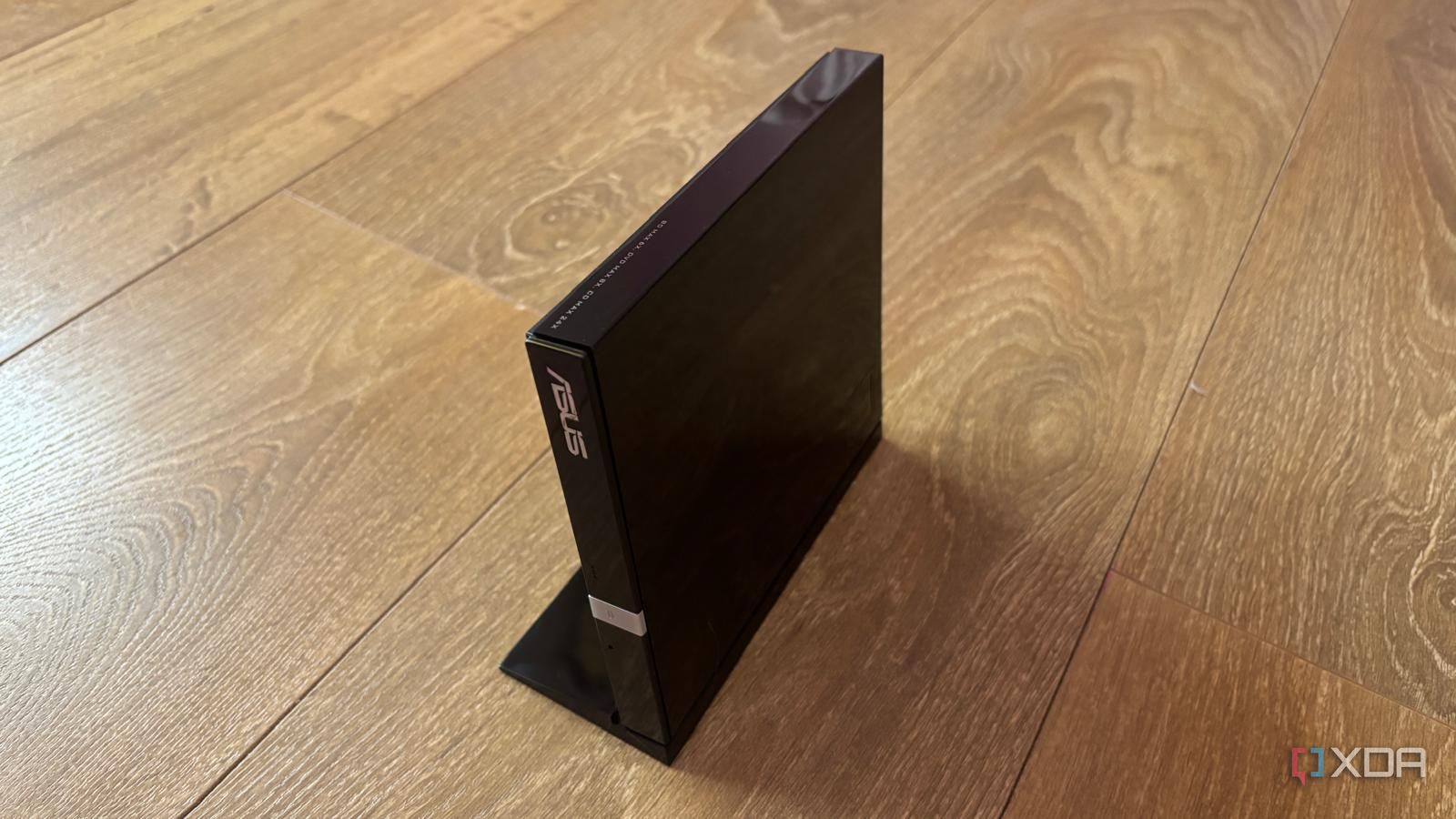 asus blu-ray writer on the floor with stand
