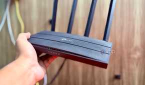 Holding the TP-Link Archer C6 router