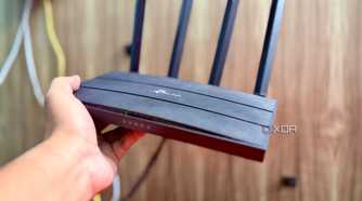 Holding the TP-Link Archer C6 router