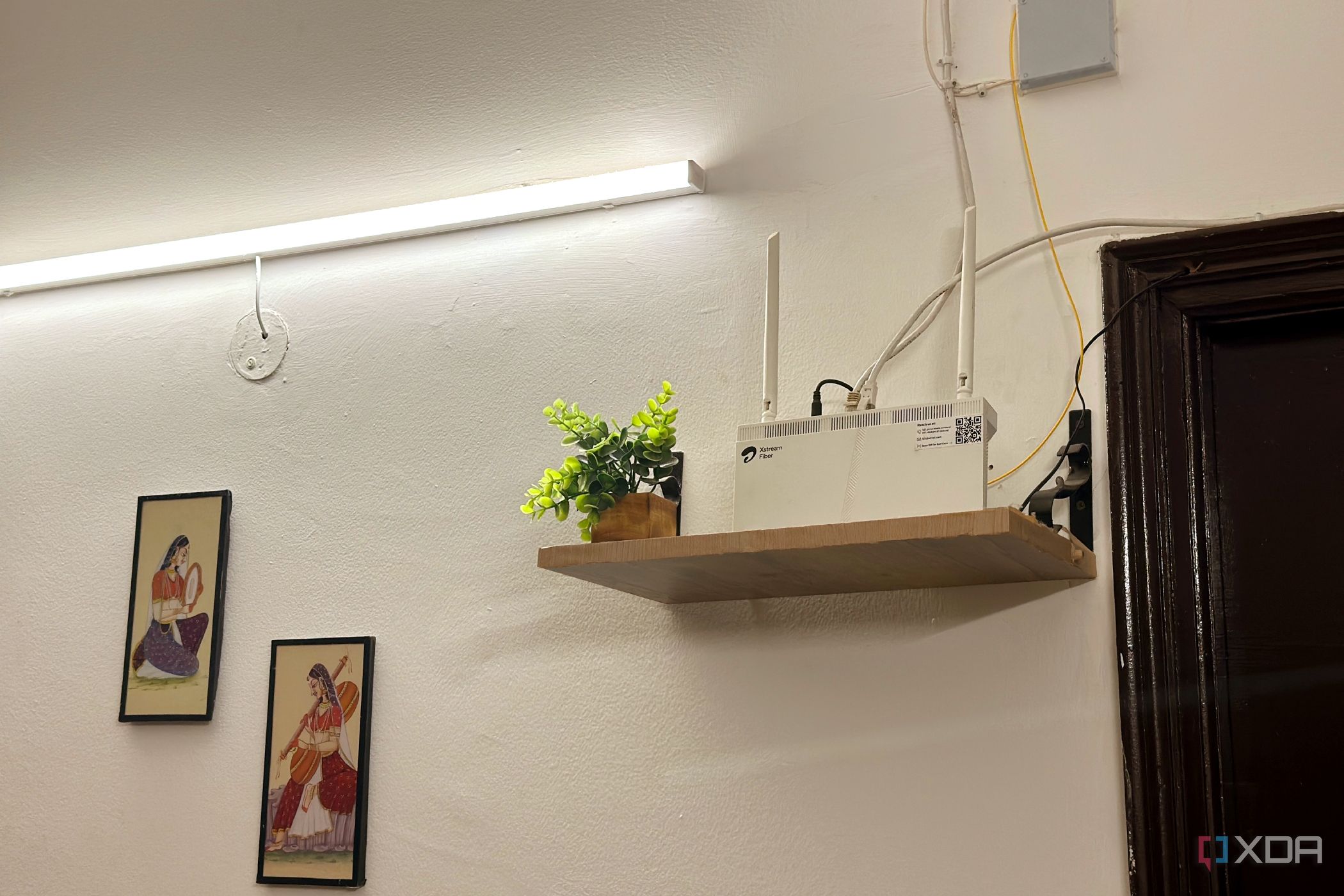 Wi-Fi router on a high wooden shelf.