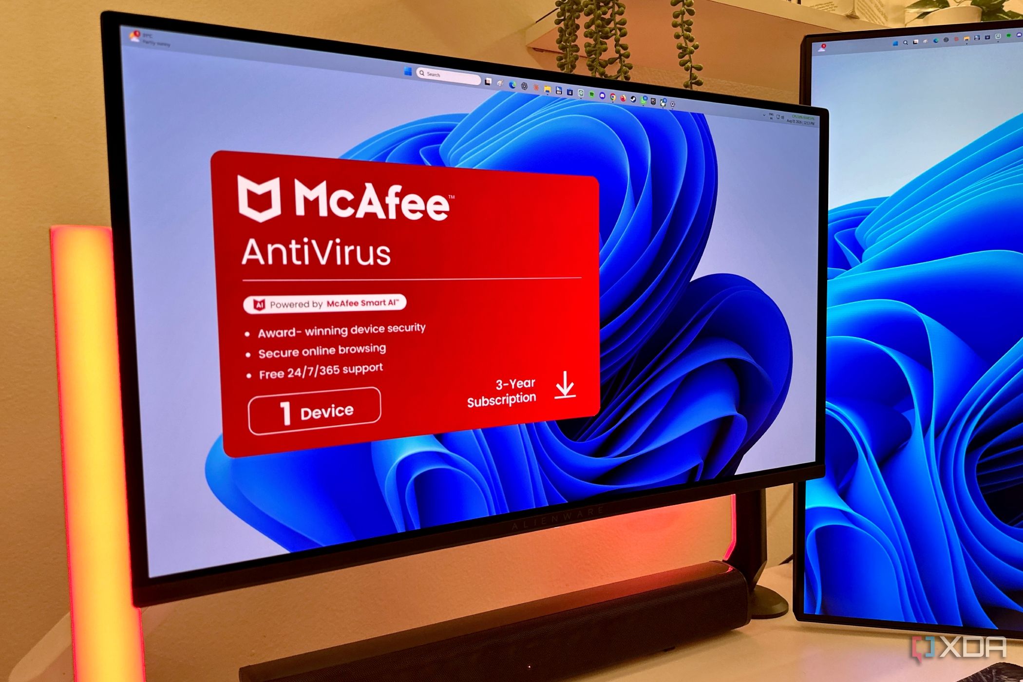 McAfee advertisement pop-up on an Alienware OLED monitor.
