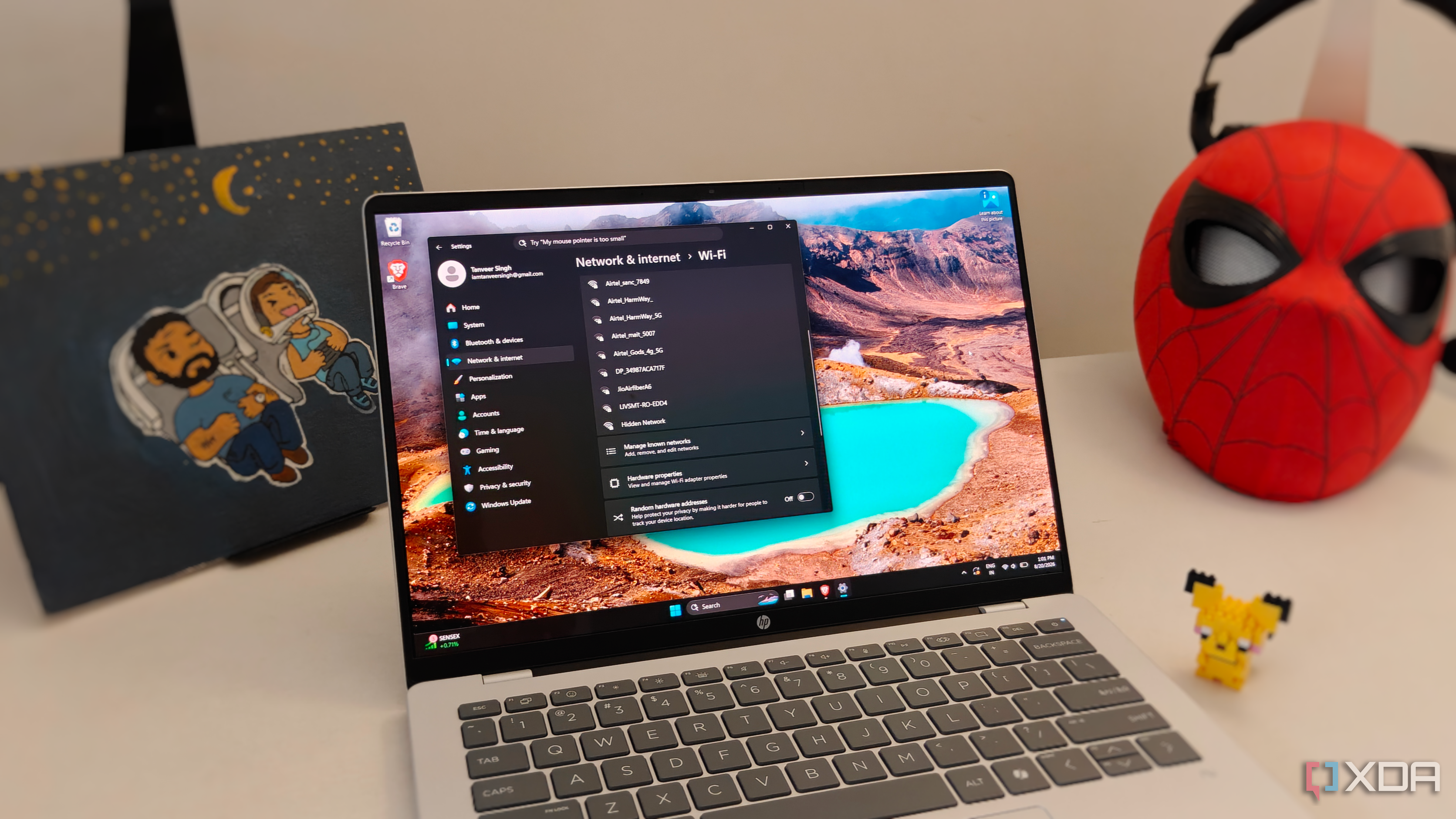 A Windows laptop next to some figurines on a white desk
