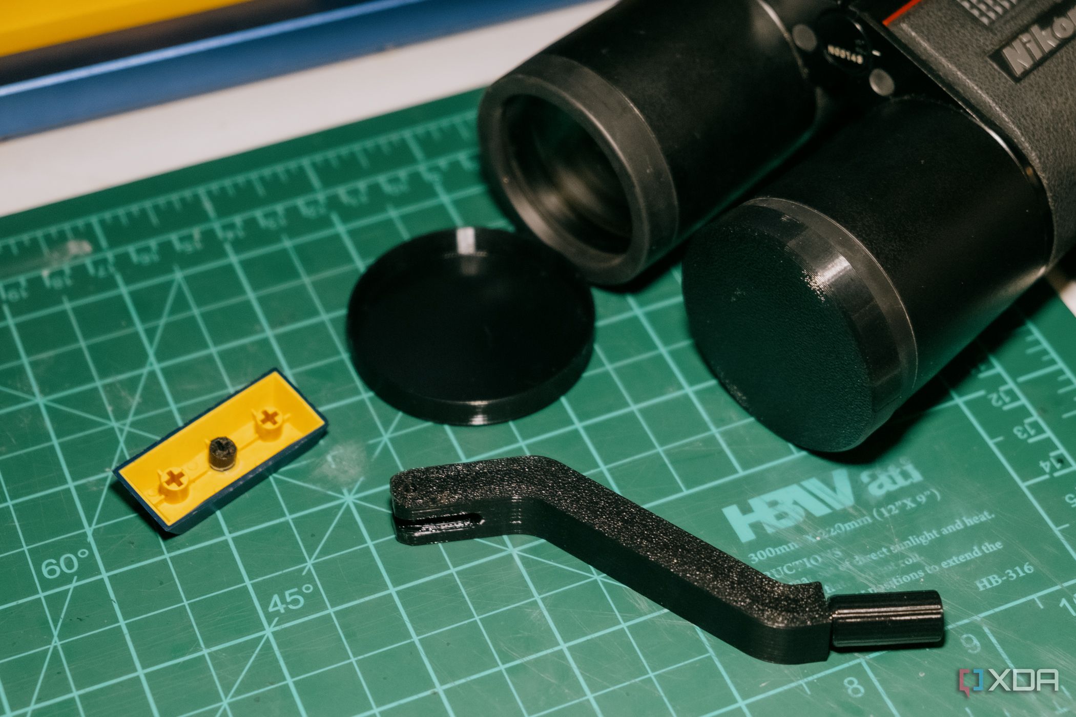 Multiple 3D-printed replacement parts on a cutting mat