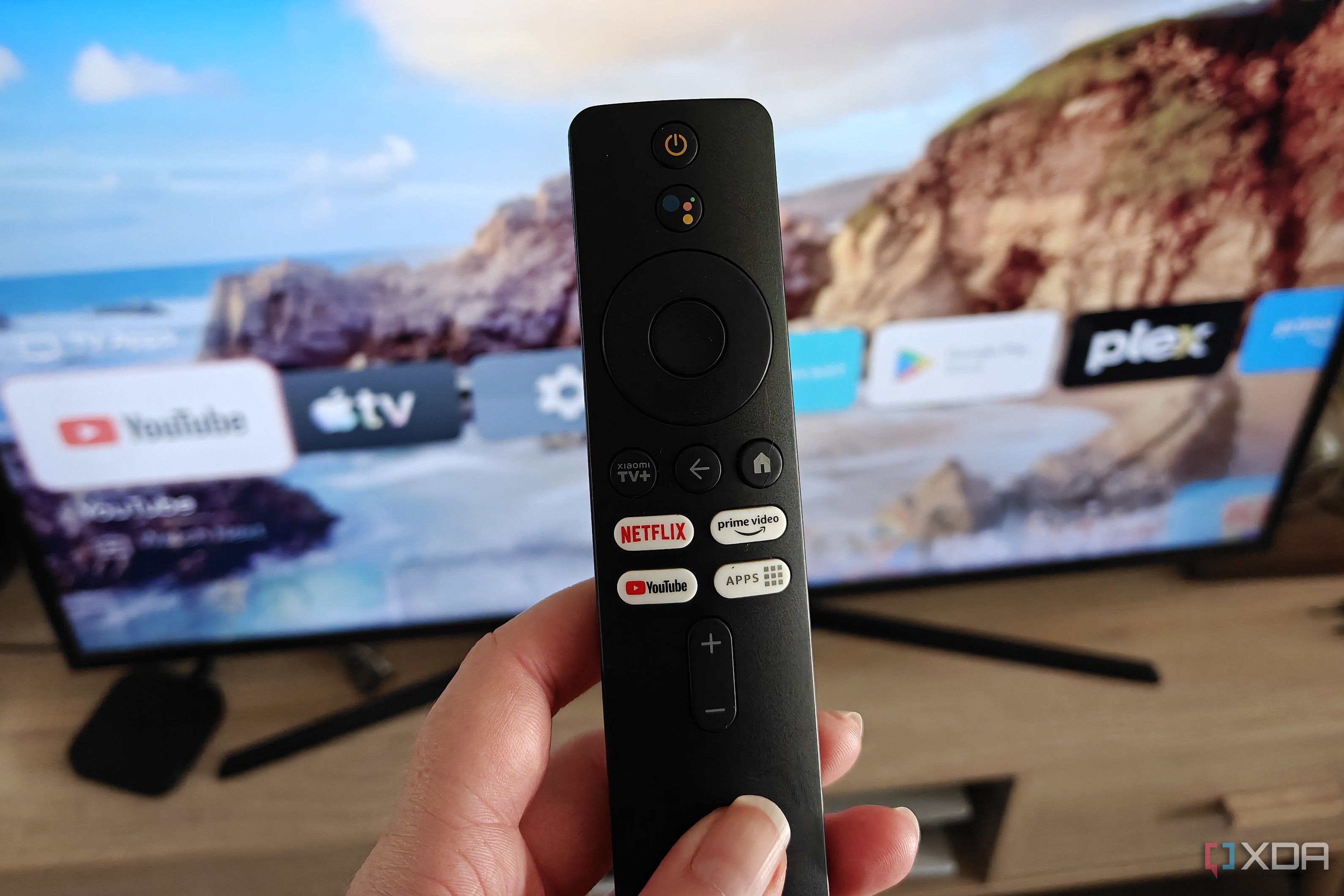 a tv remote in front of a screen with projectivity launcher