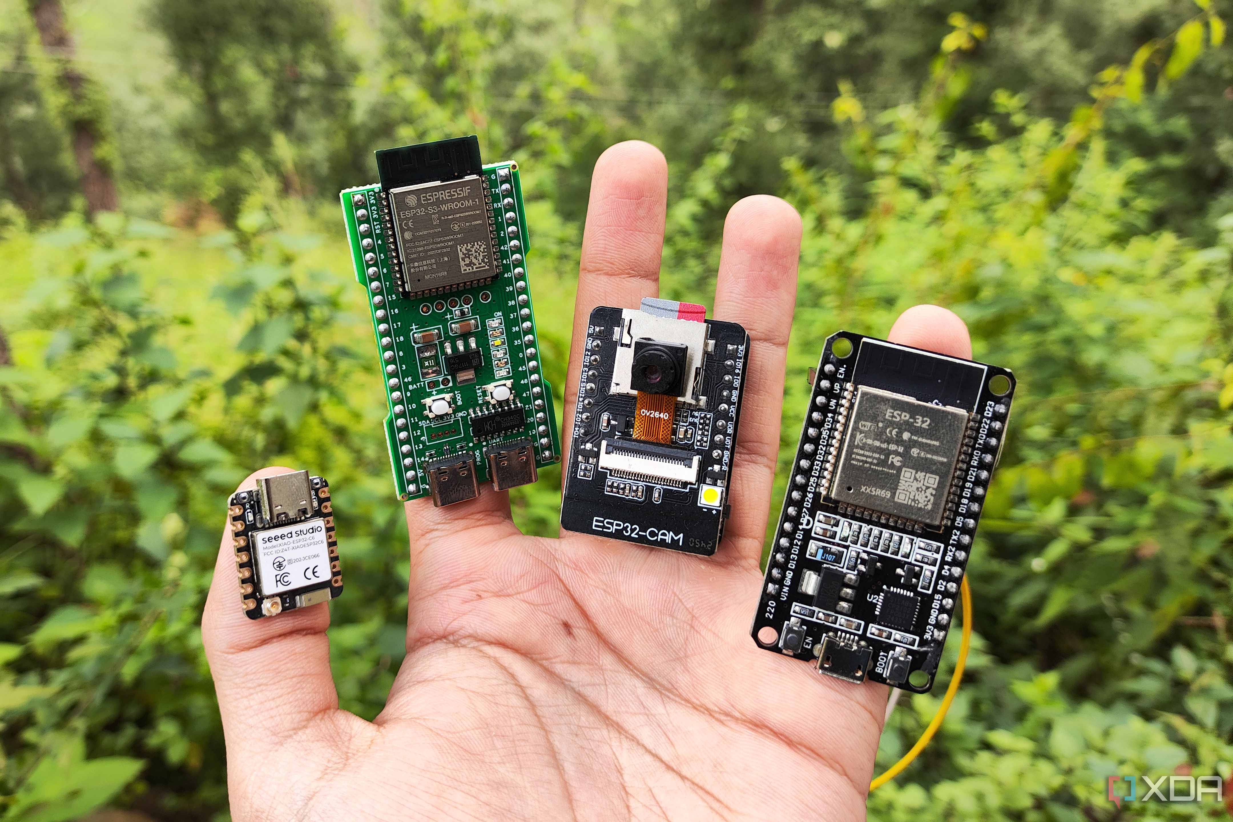 A person holding multiple ESP32 boards
