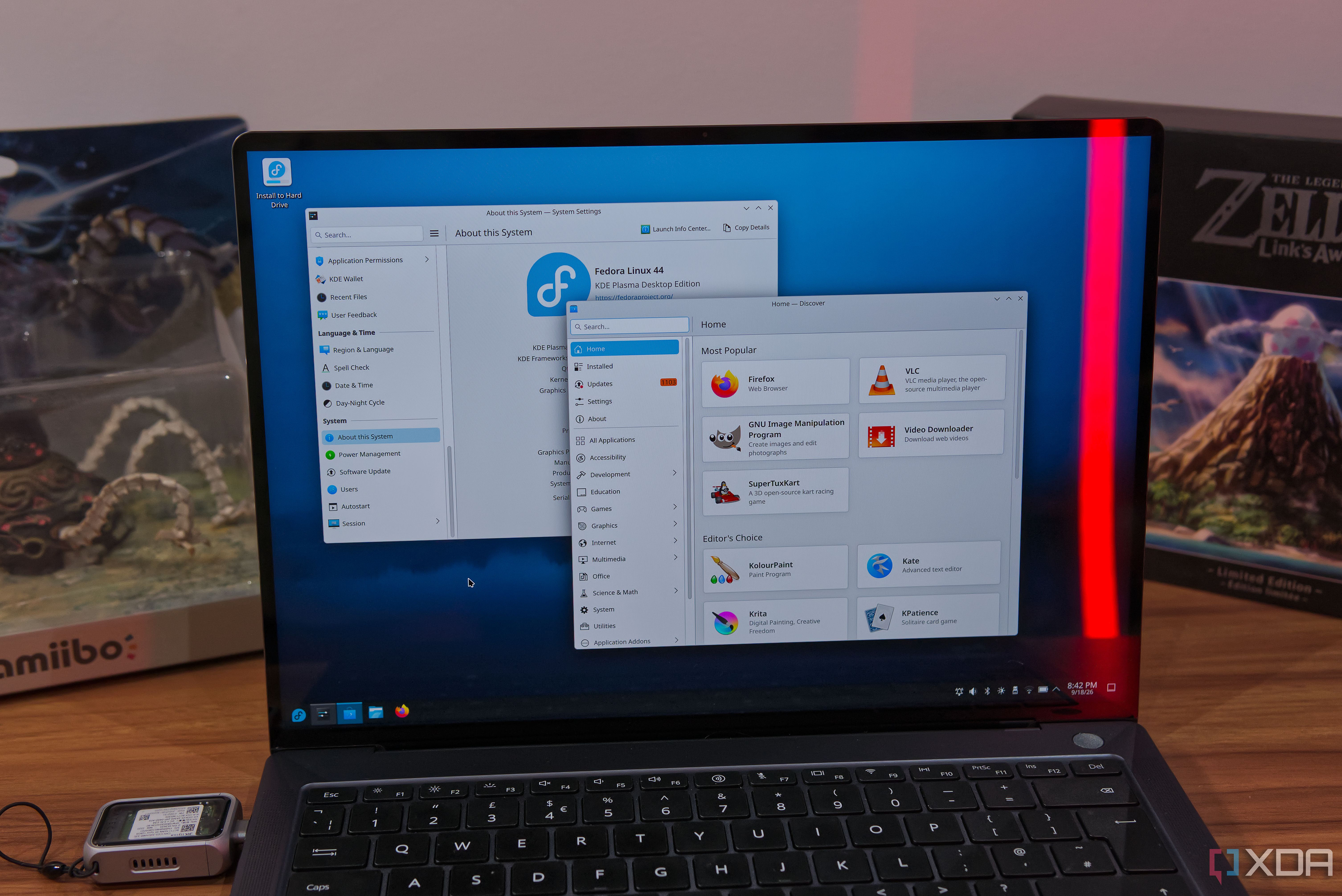 A laptop running Fedora KDE, showing the System settings app and the Discover store