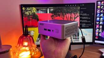 Immich in background with mini pc being held up in front of it