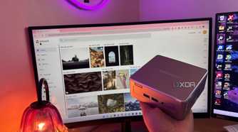 Immich in background with mini pc being held up in front of it