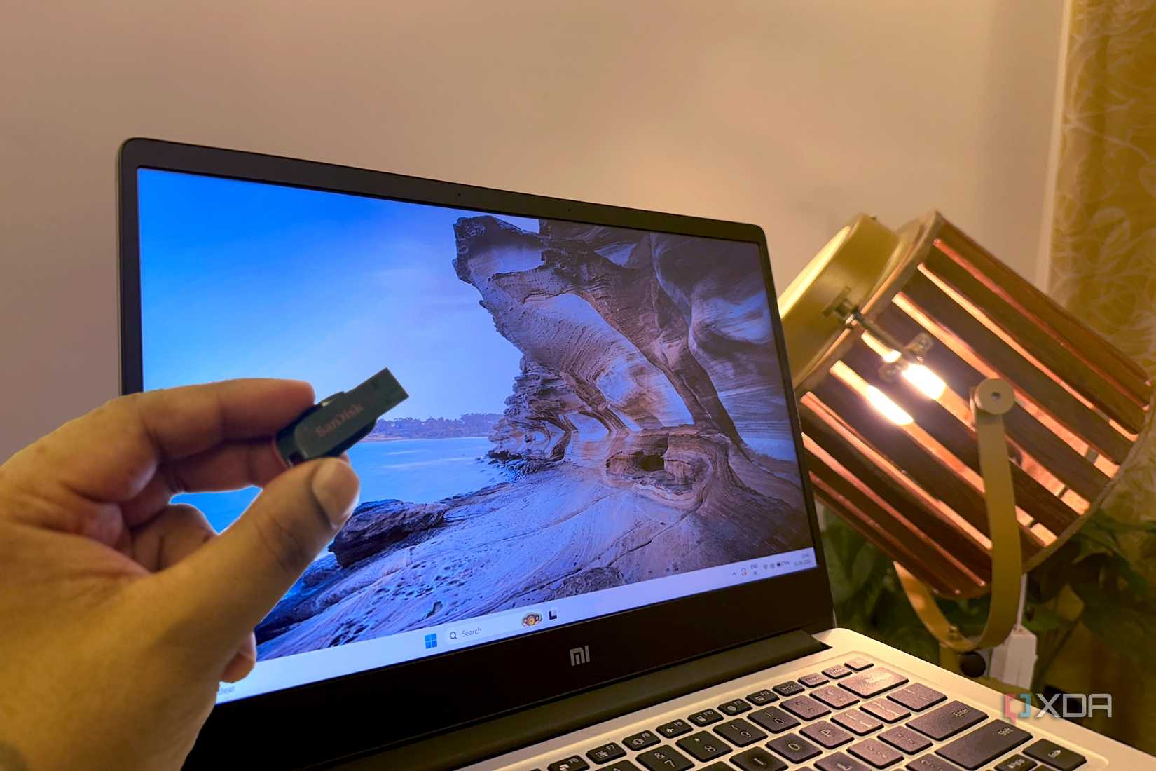 Portable USB drive with a fresh Windows 11 desktop on a laptop.