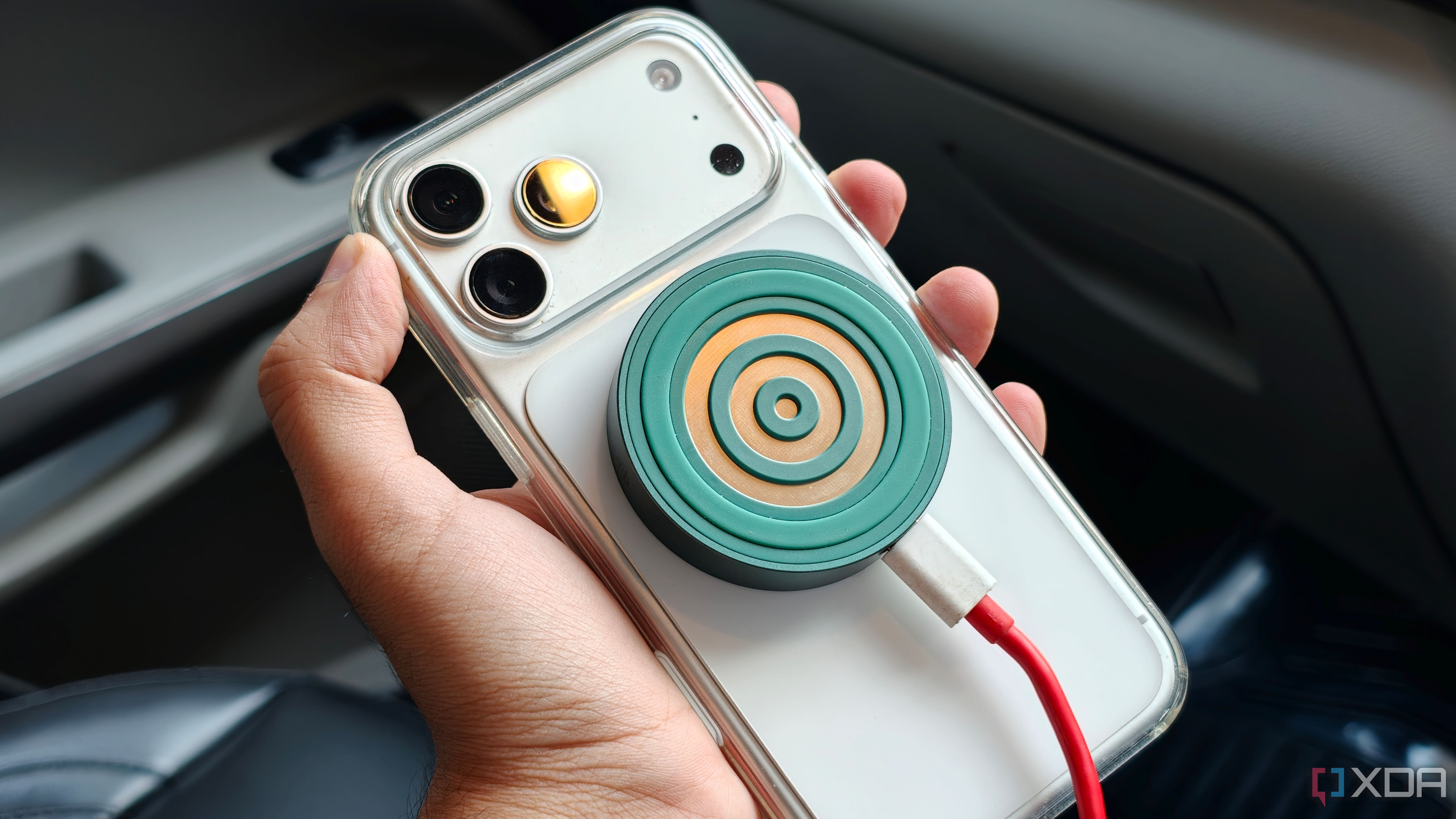 Qi charger via 12v socket in car connected to iPhone close up