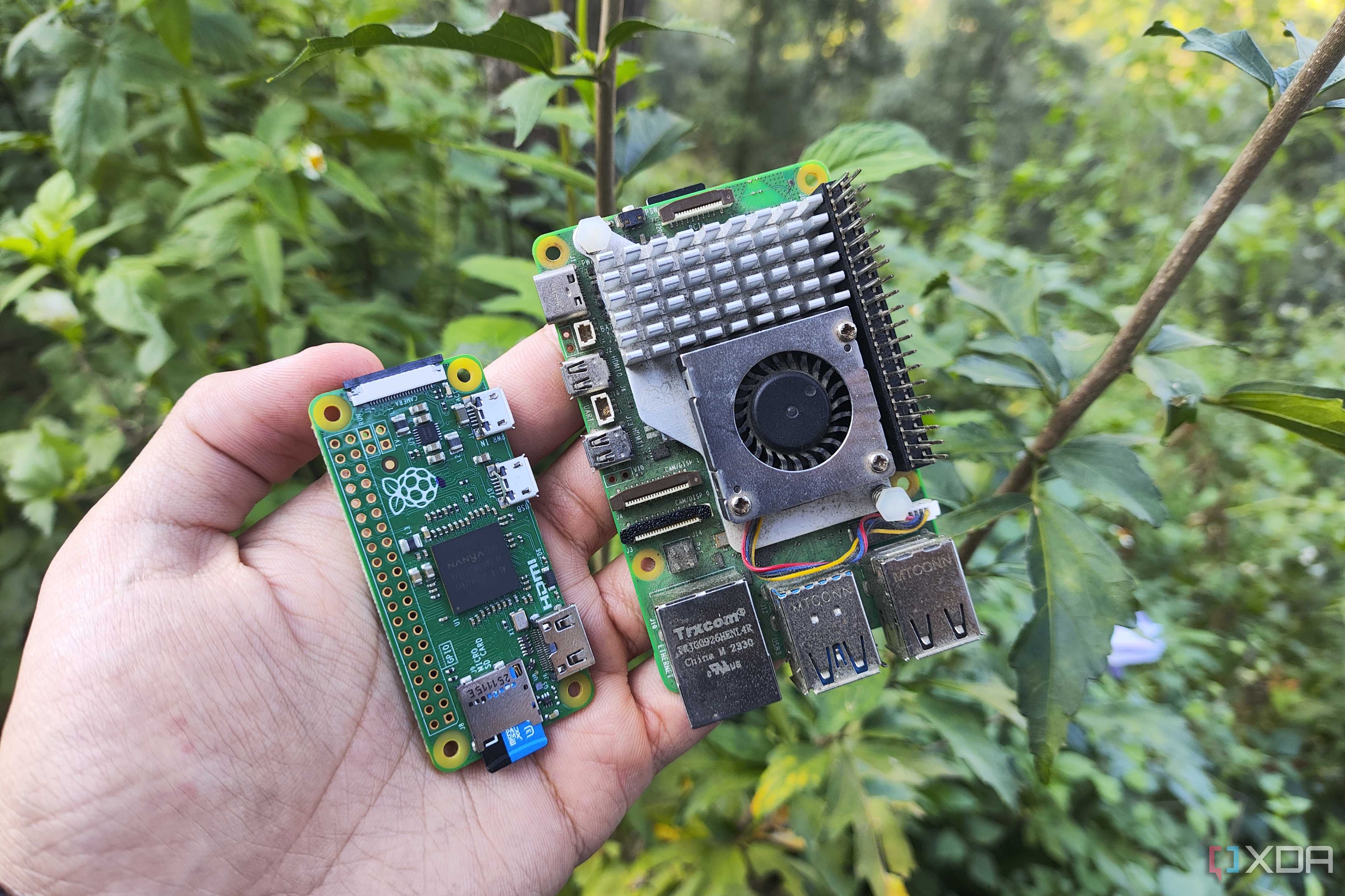 A person holding two Raspberry Pi SBCs