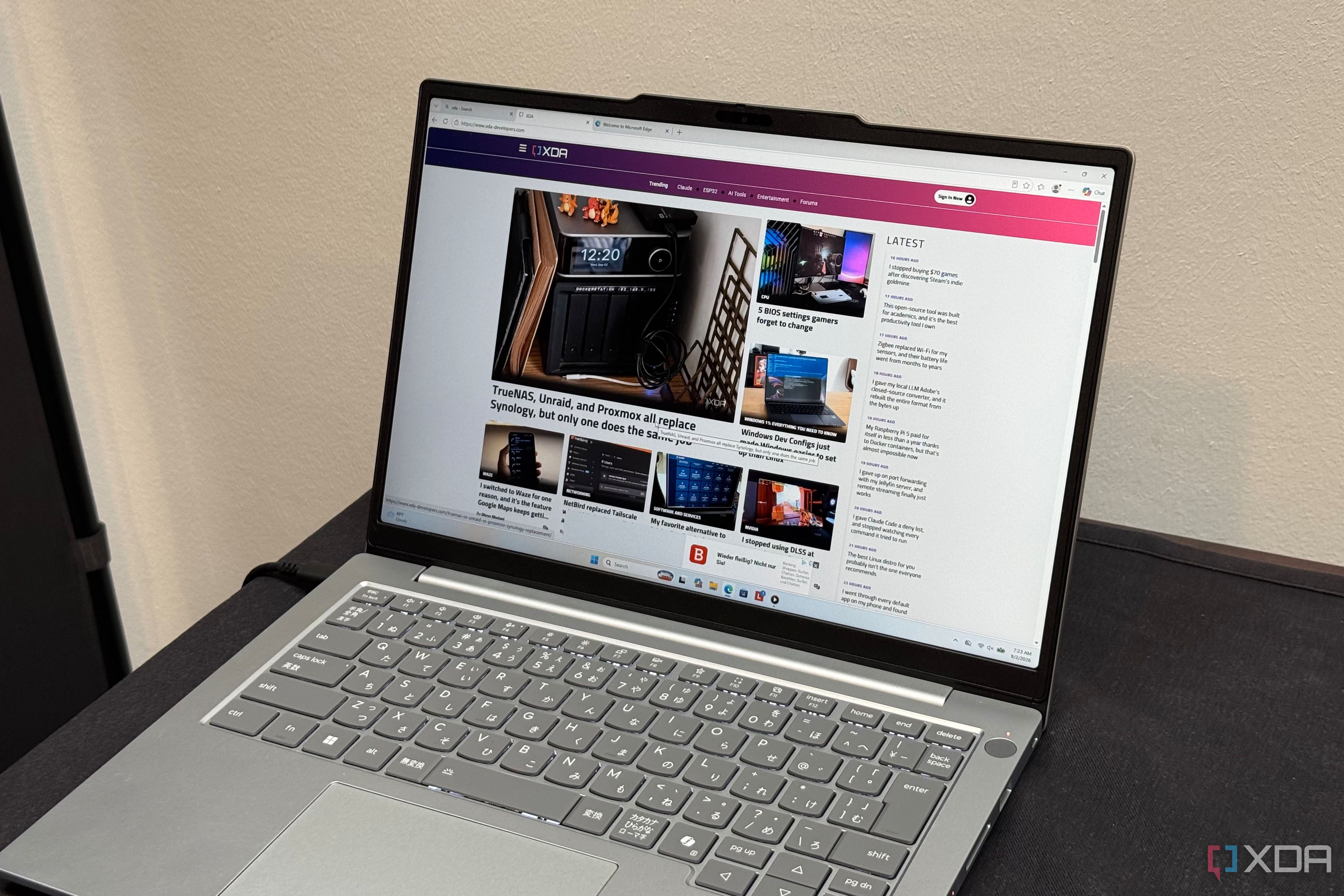 Silver Lenovo ThinkBook with a Japanese keyboard showing XDA in Edge
