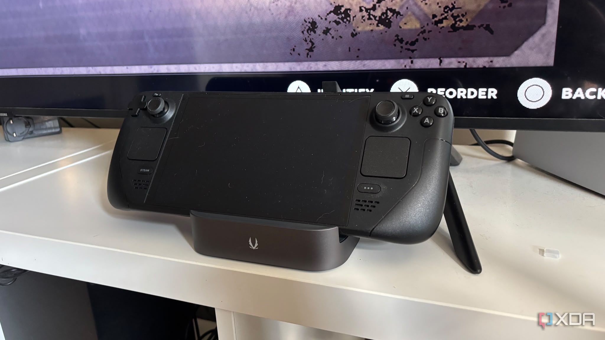 Steam deck in dock on TV being shown off