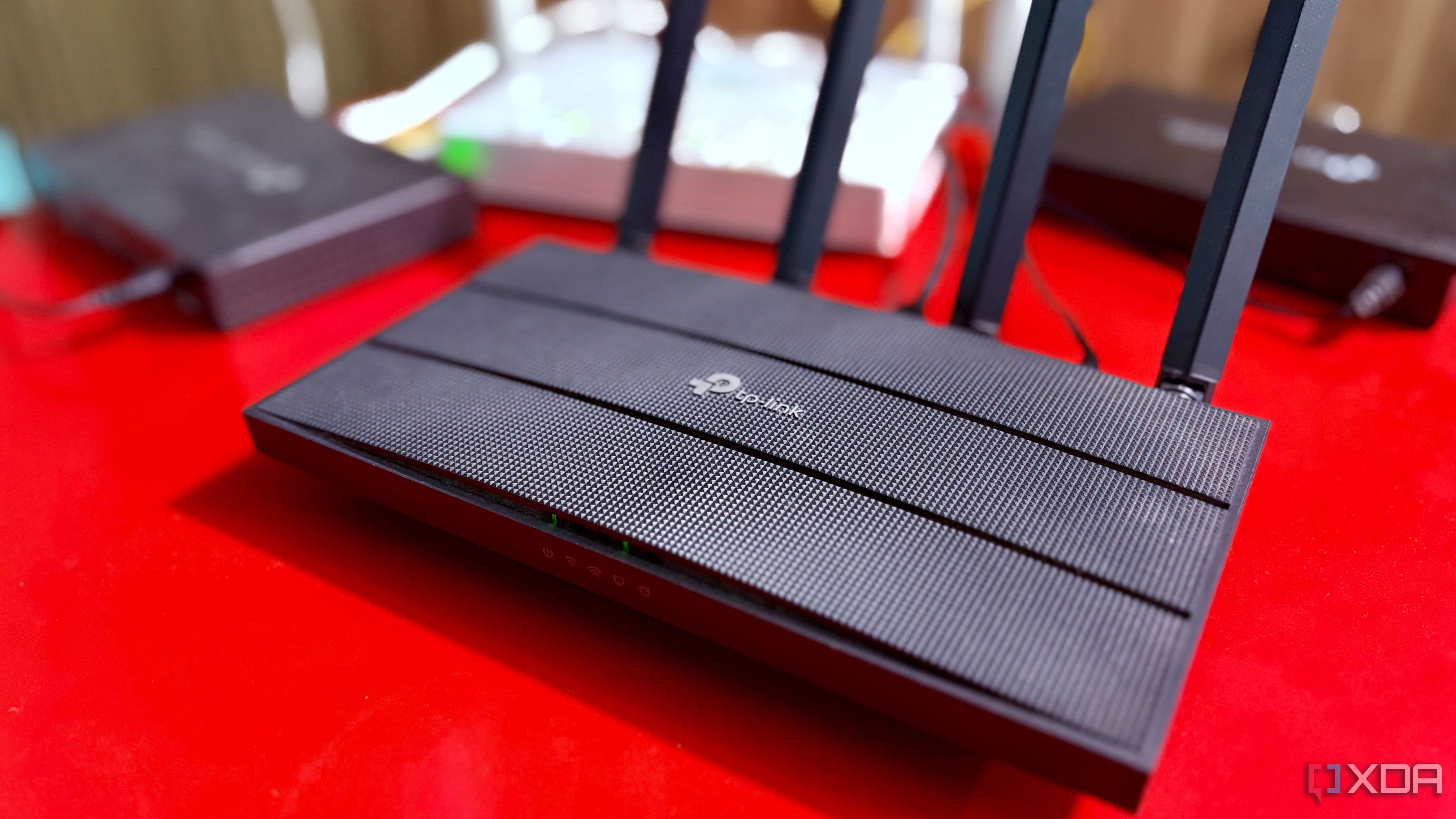 TP-Link Archer C6 router in close-up, with other network hardware in the background