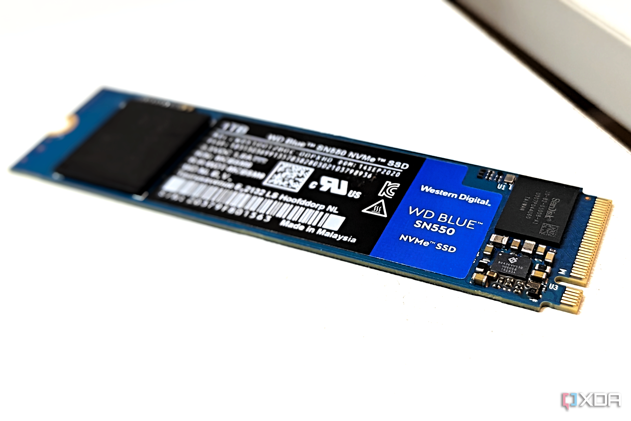 Close-up of an NVMe SSD with a blue PCB showing the onboard controller