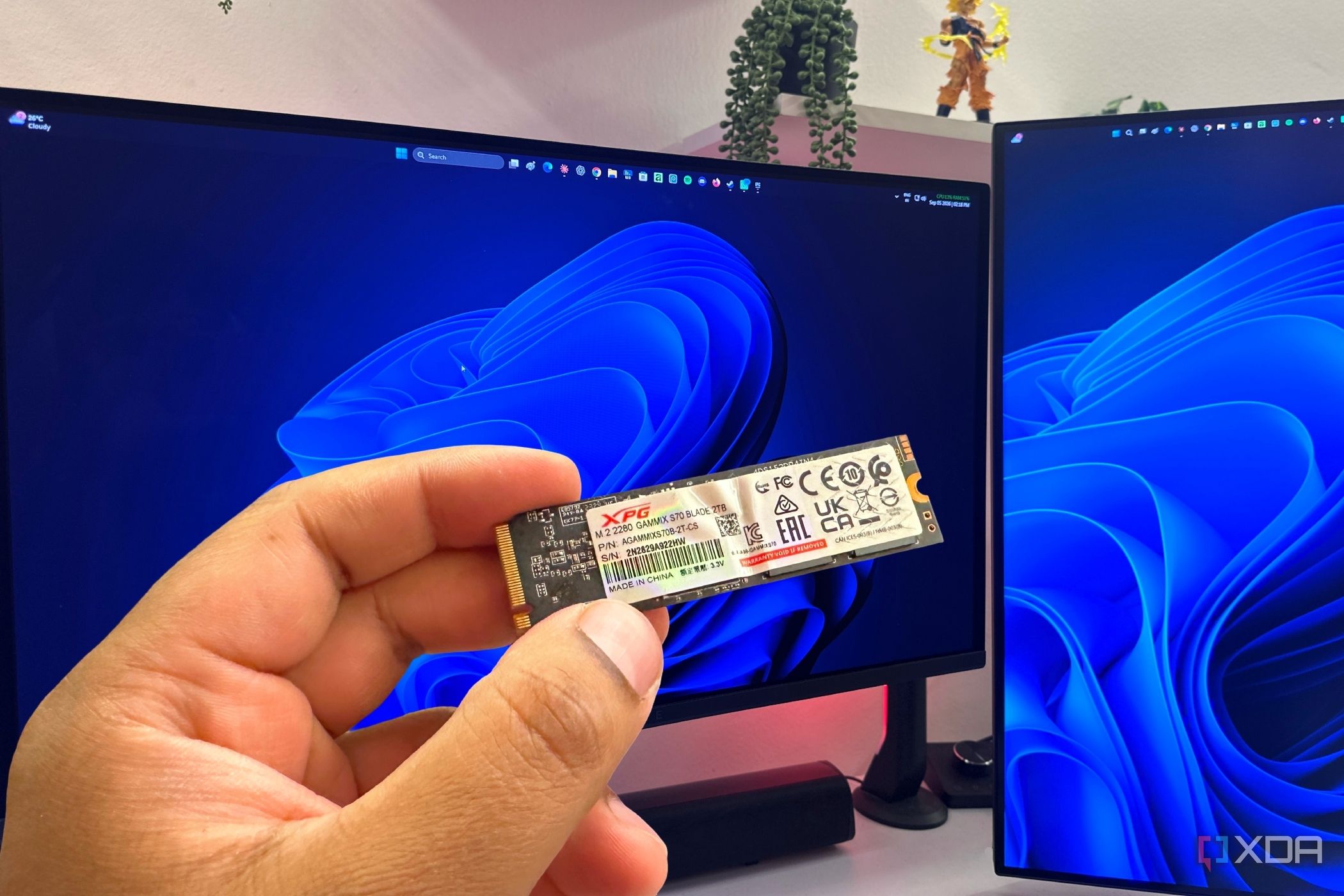 Windows 11 PC with an NVMe SSD in the hands of a user.
