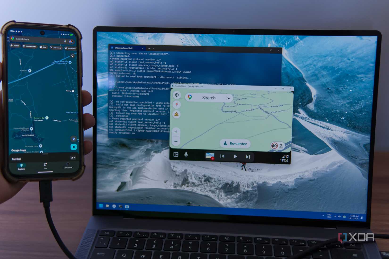 An Android phone running Google Maps next to a computer running the Android Auto DHU with Google maps on the display