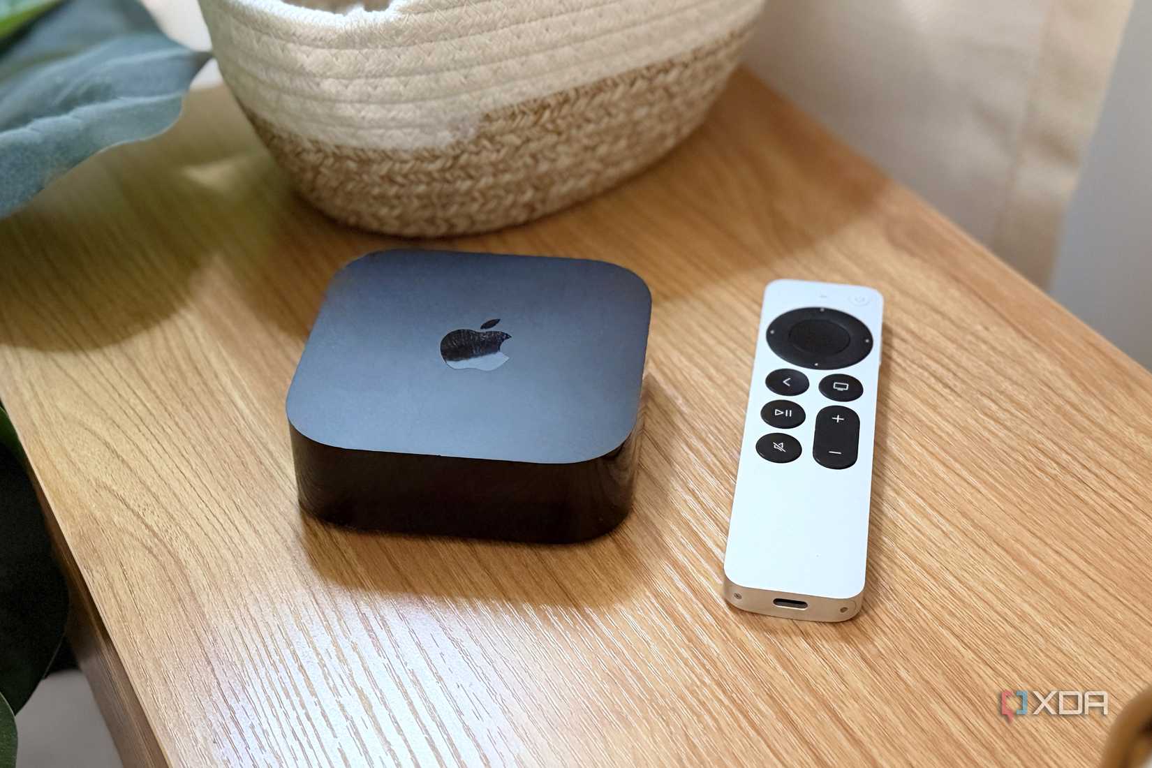 apple tv 4k on shelf next to siri remote