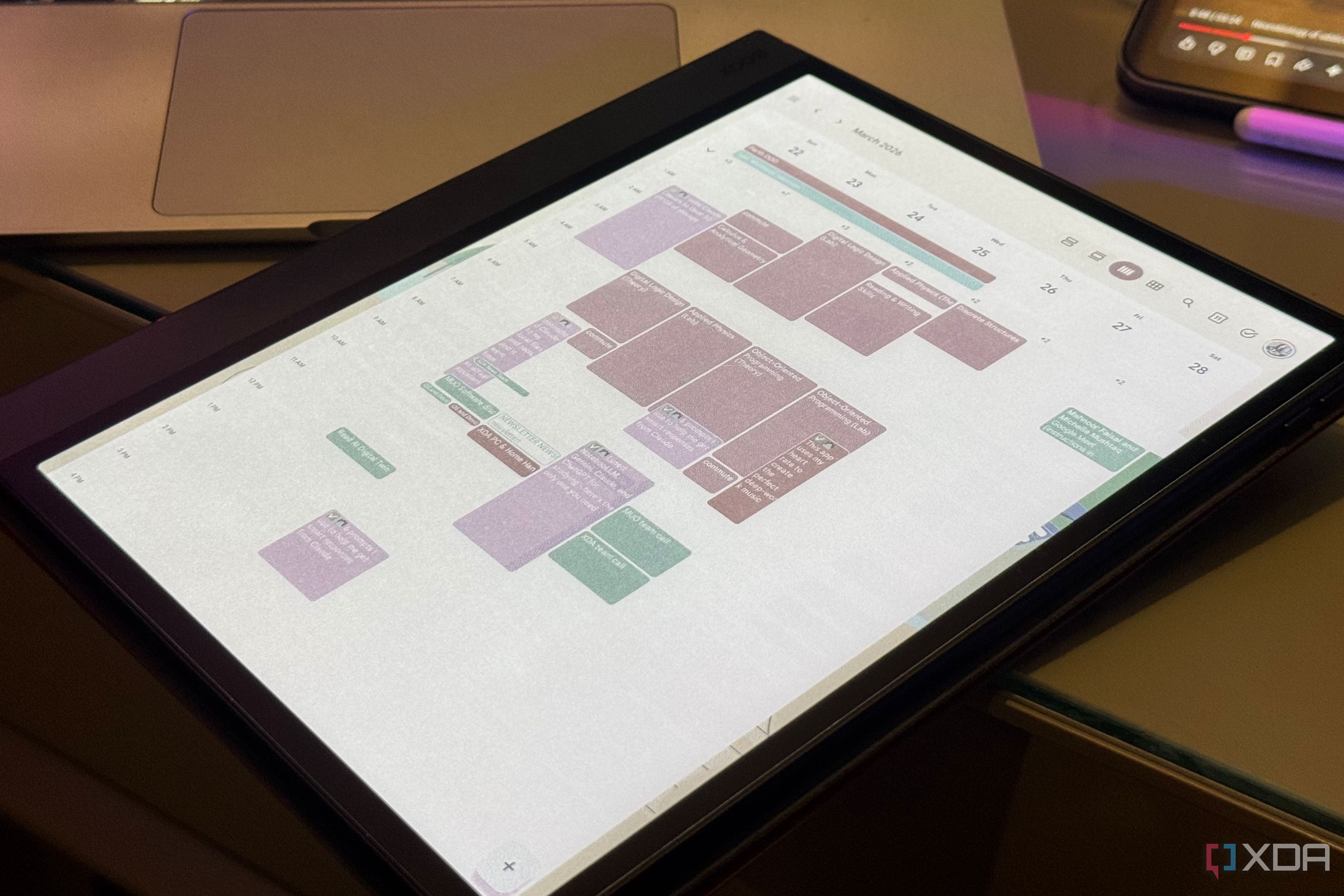 Boox color E Ink tablet showing a March week in Google Calendar beside a laptop and phone