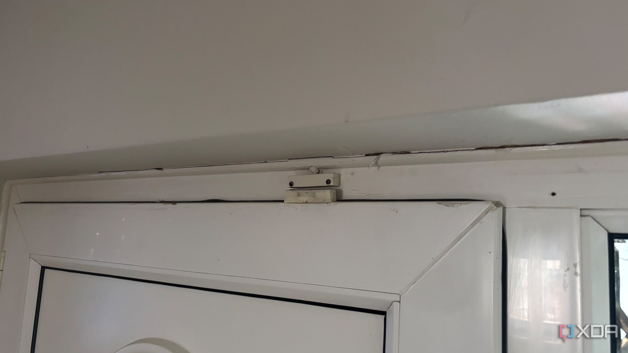 contact sensor on top of white door 