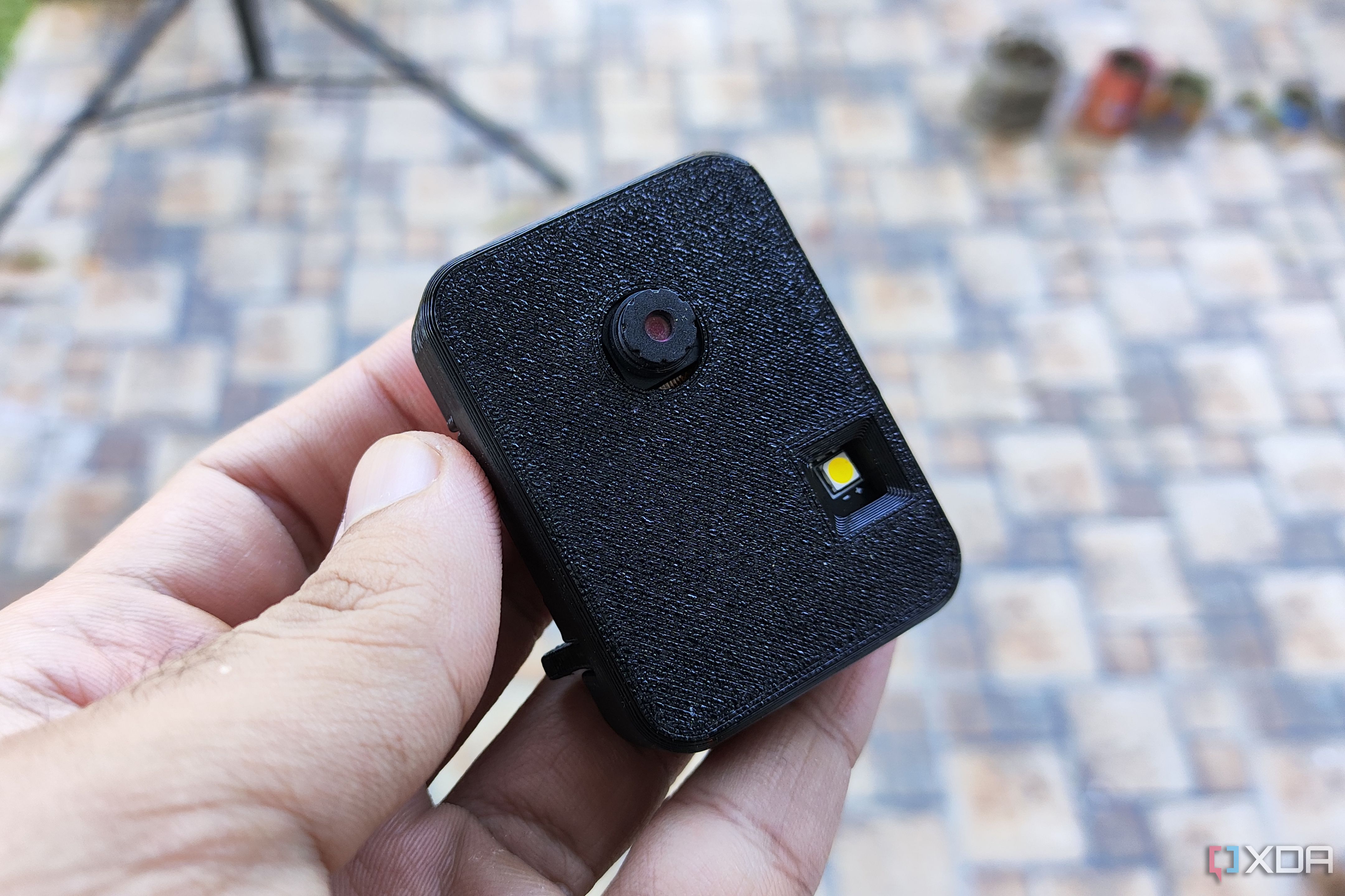 A person holding a 3D printed ESP32-CAM case