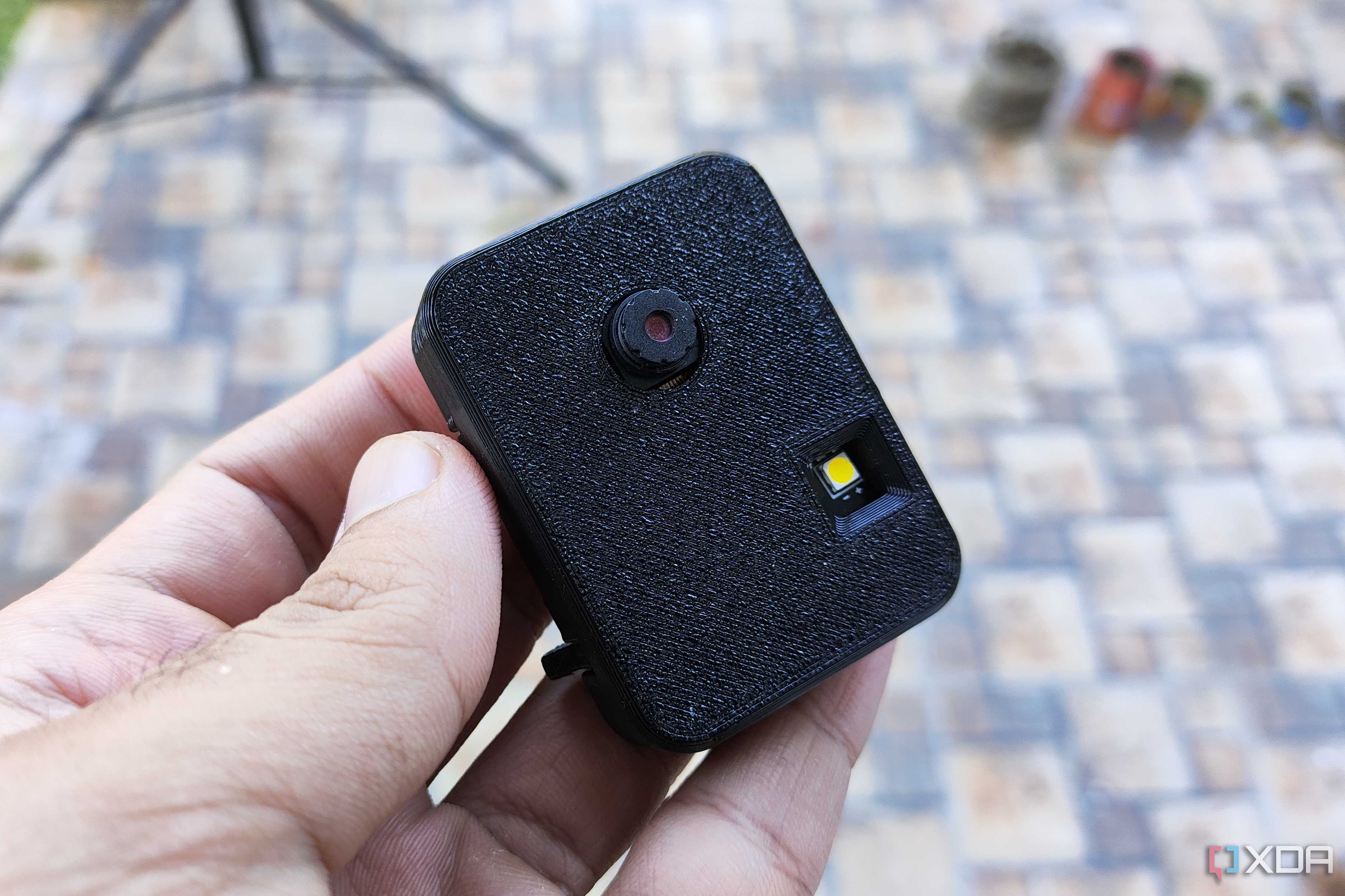 A person holding a 3D printed ESP32-CAM case