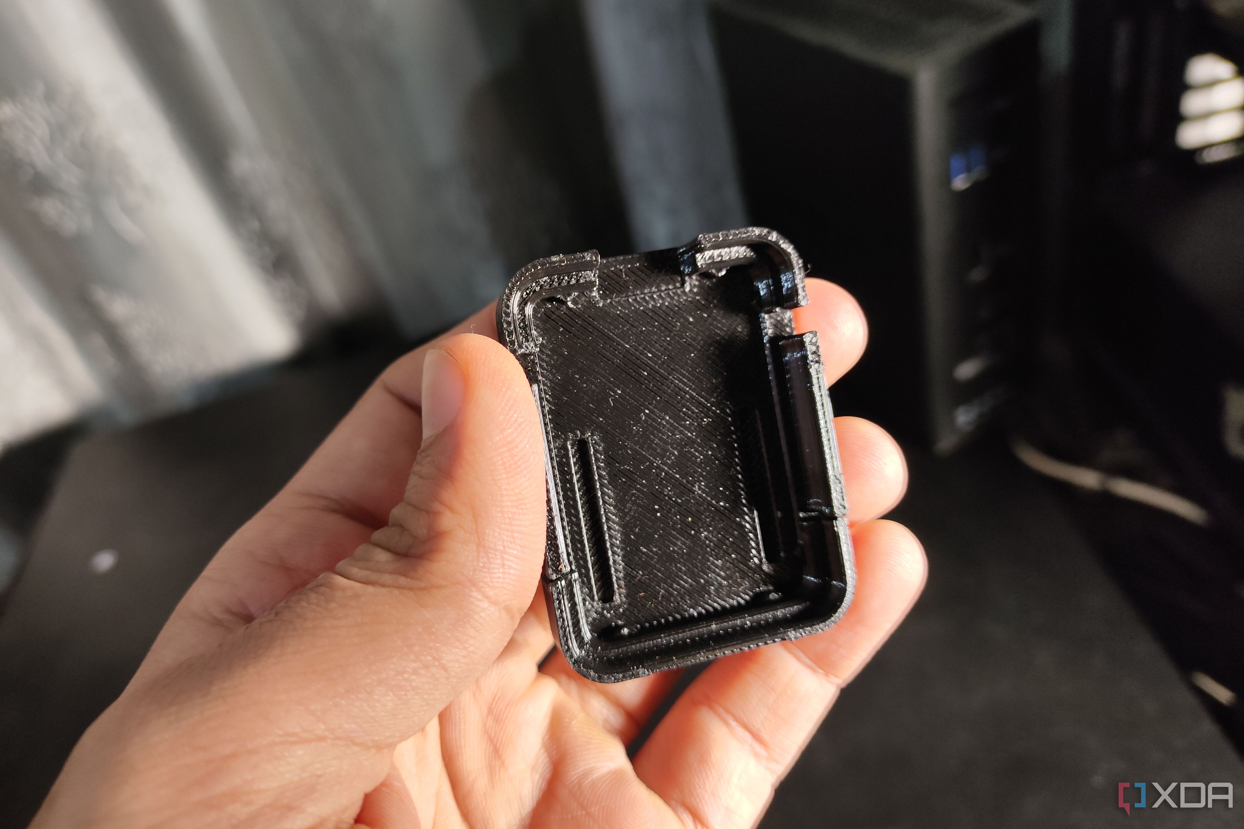 A person holding an ESP32-CAM case