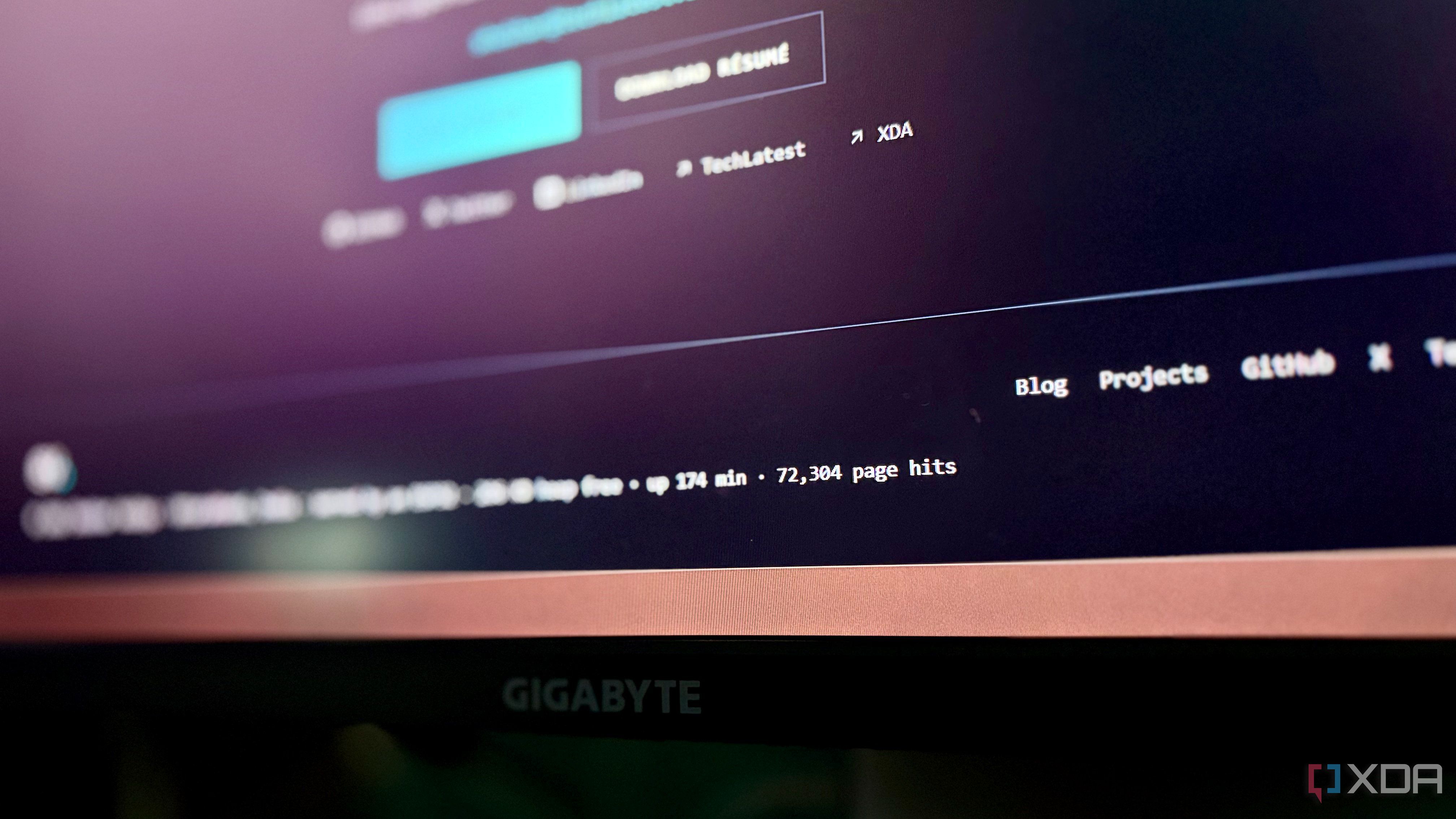 Monitor showing the portfolio footer at 72,304 page hits after almost three hours of uptime