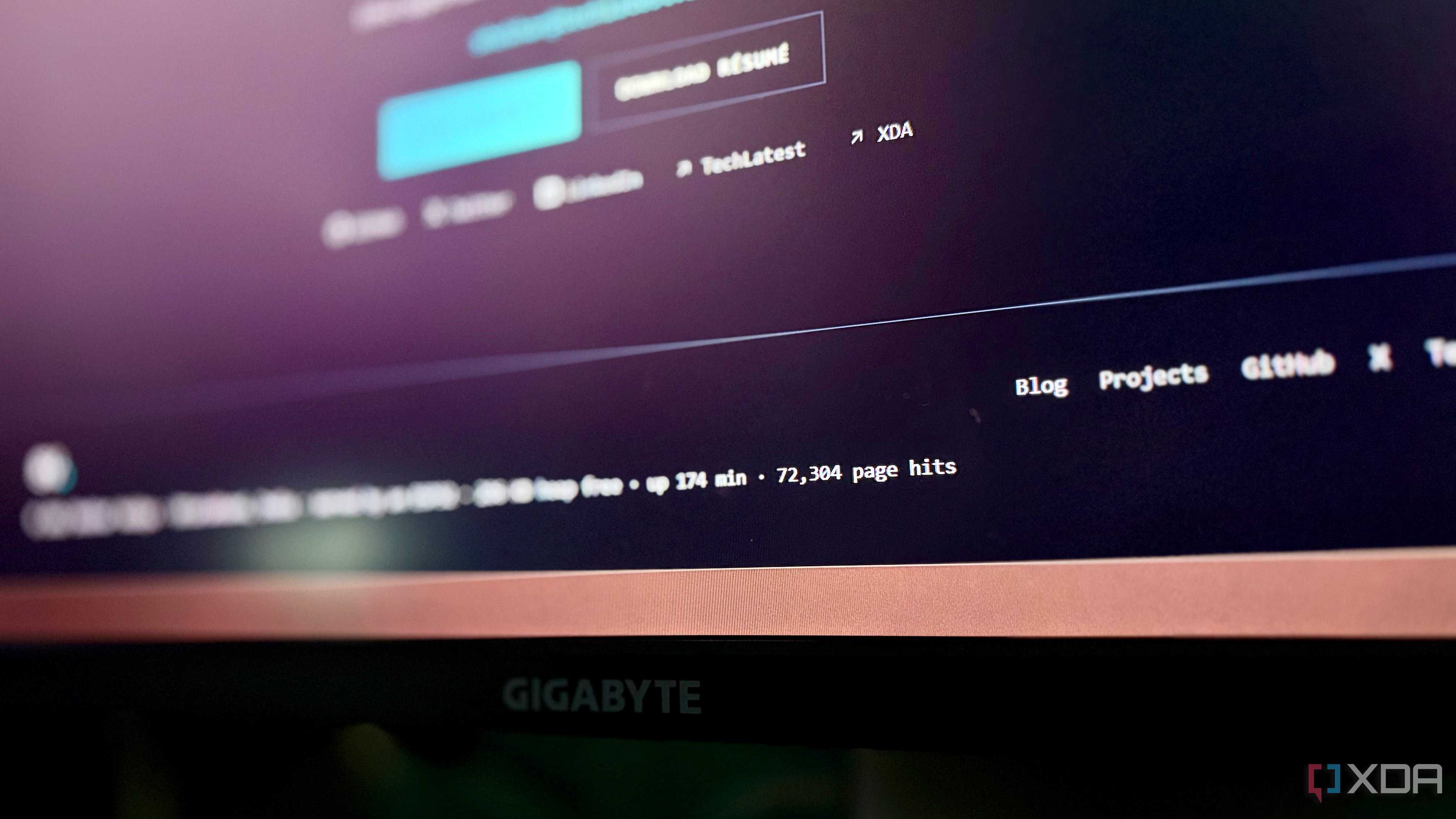 Monitor showing the portfolio footer at 72,304 page hits after almost three hours of uptime