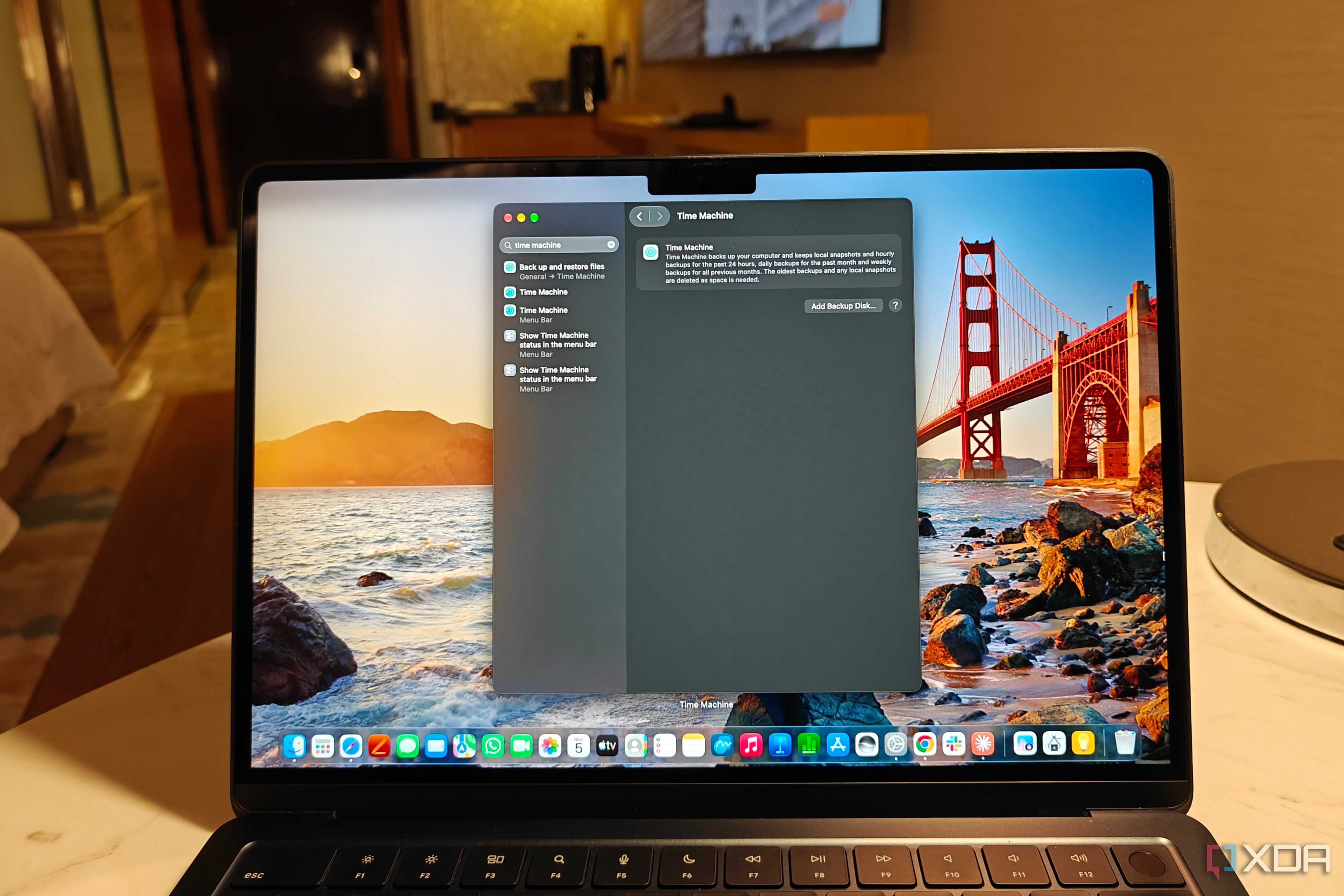 macbook air m2 on a table showing time machine in settings tab