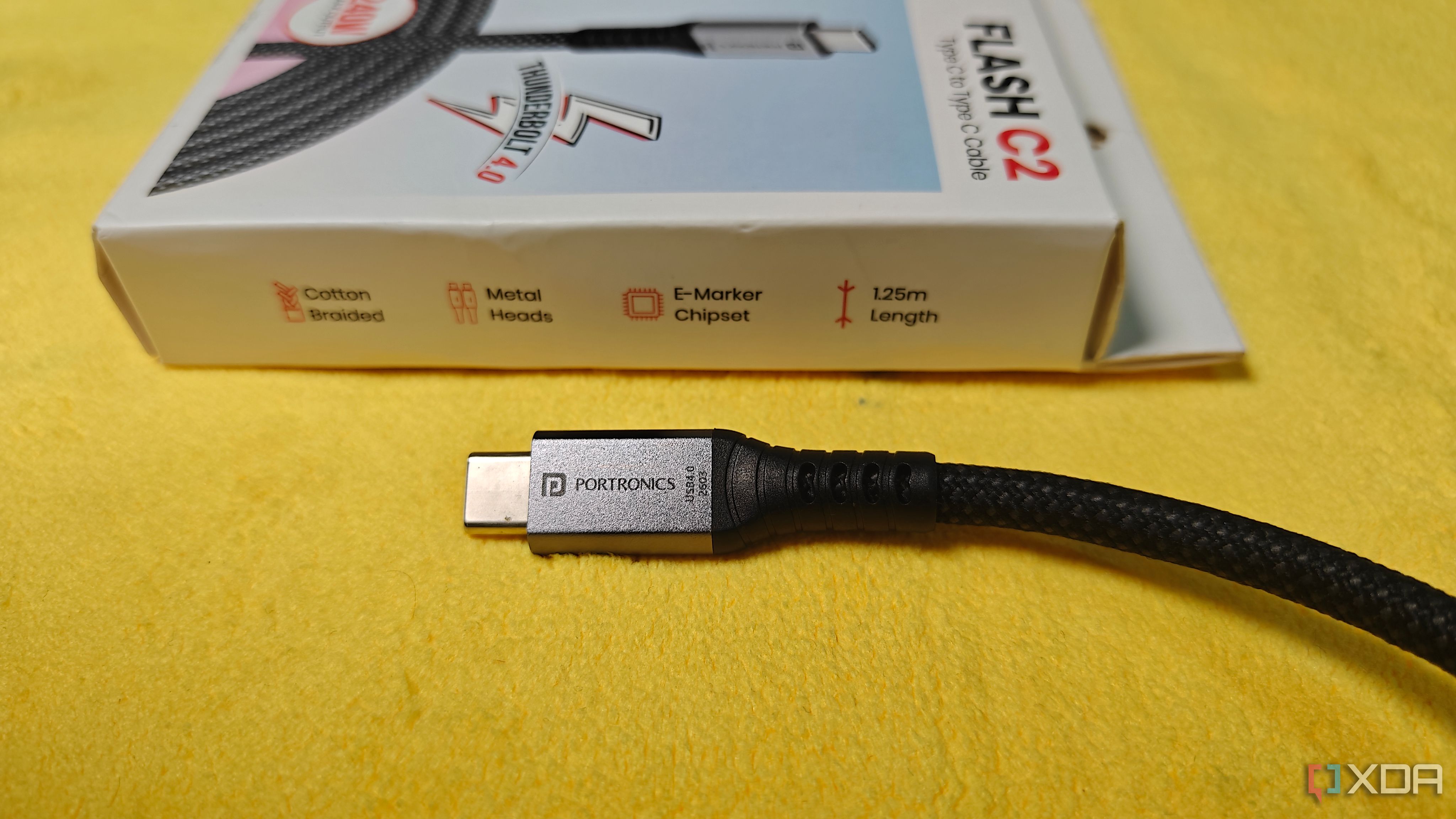 a portronics flash c2 plug etched with usb4.0 in front of its box listing an e marker chipset and a 1.25m length