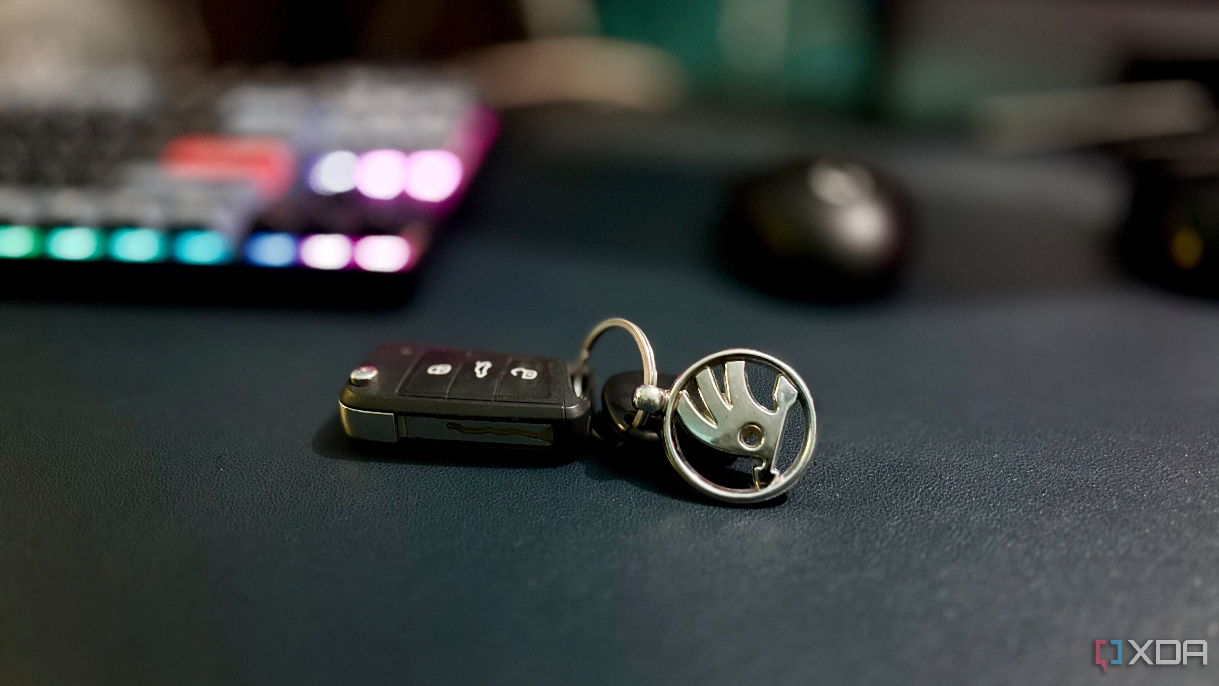 Kushaq flip key with lock, boot release and unlock buttons, and a Skoda keychain