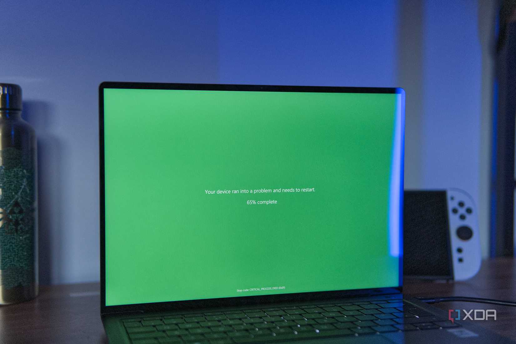 A Windows 11 laptop showing a Green screen of death, the equivalent of a BSOD for Windows Insiders