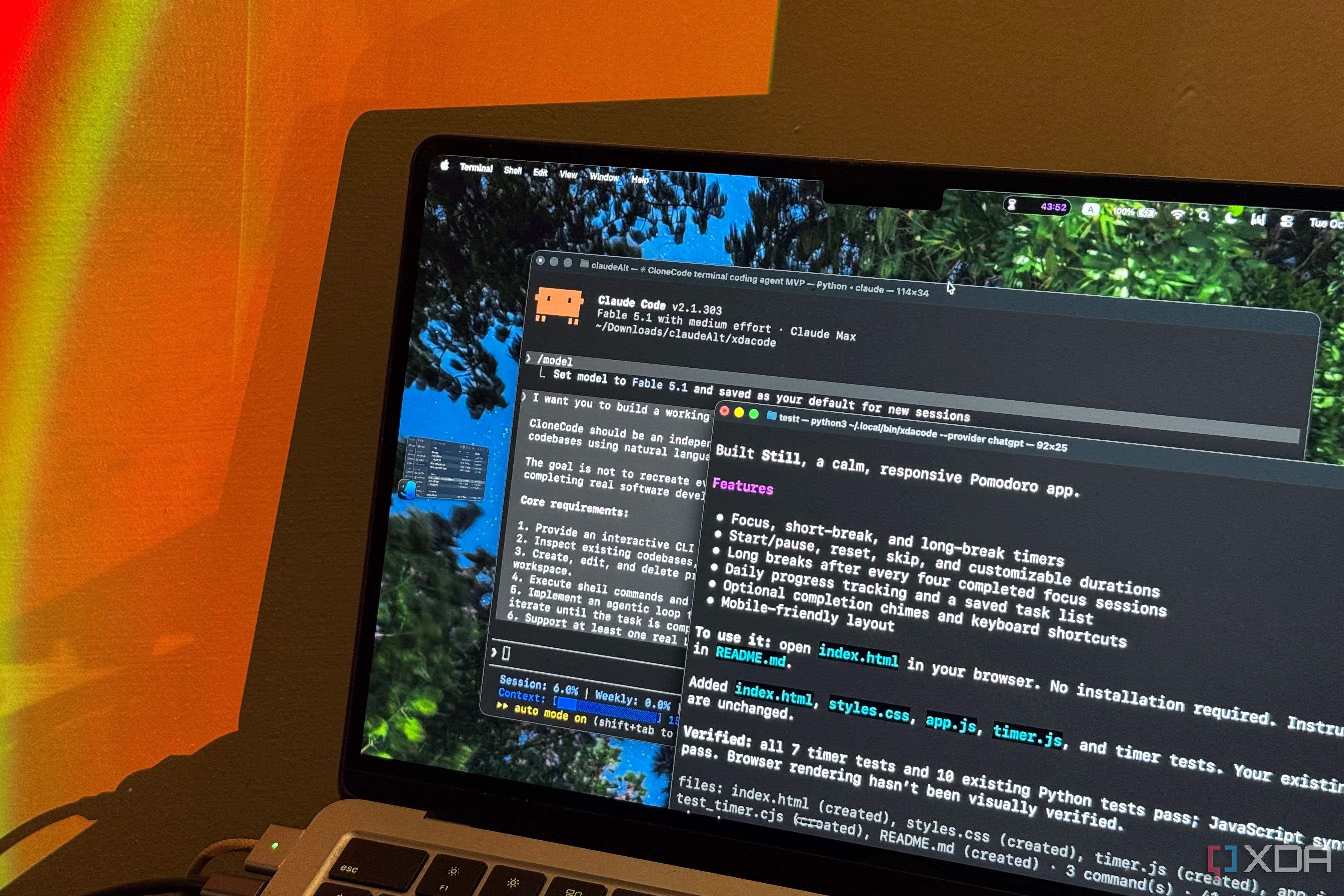 MacBook Air under orange lamp light showing Claude Code and the Still pomodoro summary