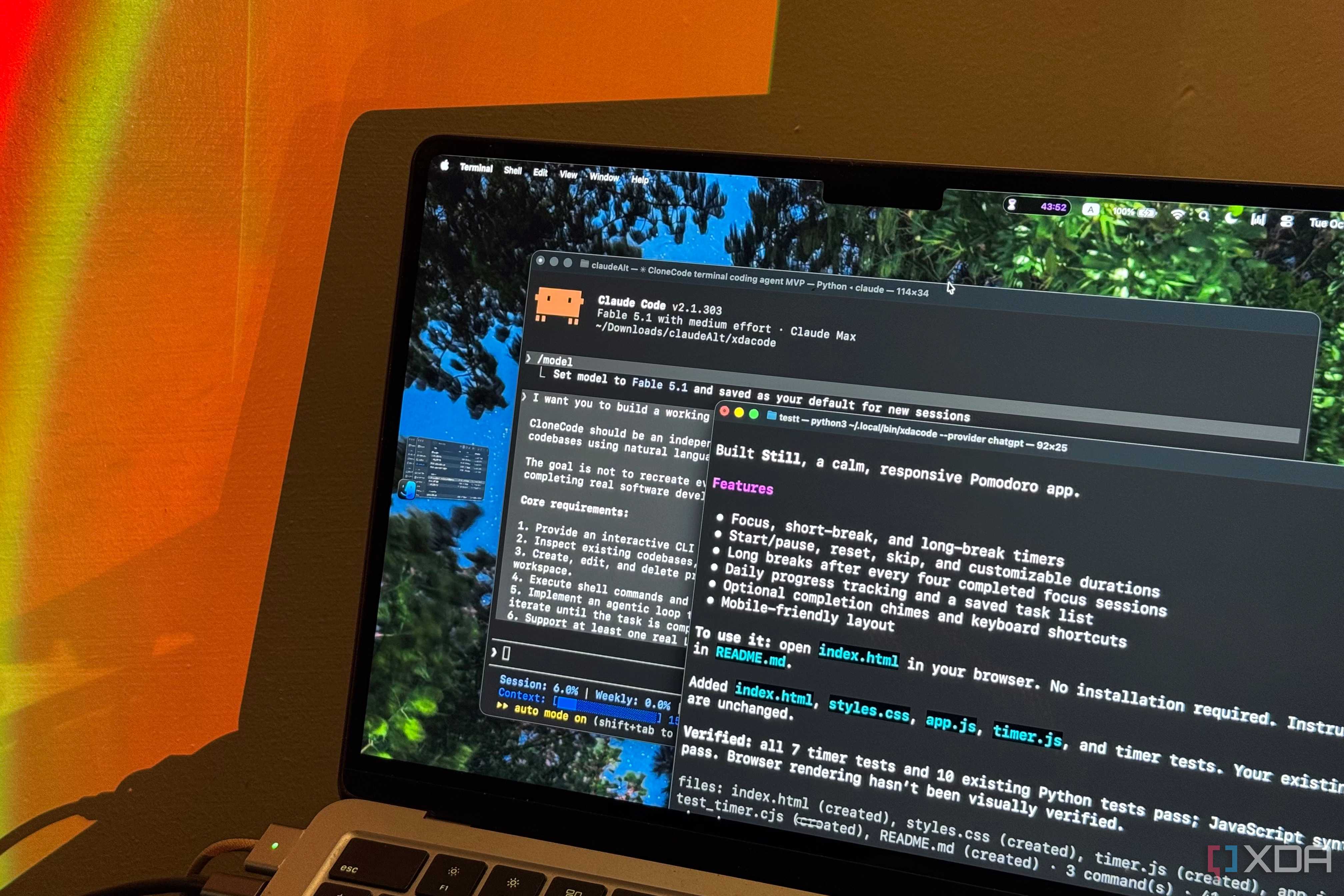 MacBook Air under orange lamp light showing Claude Code and the Still pomodoro summary