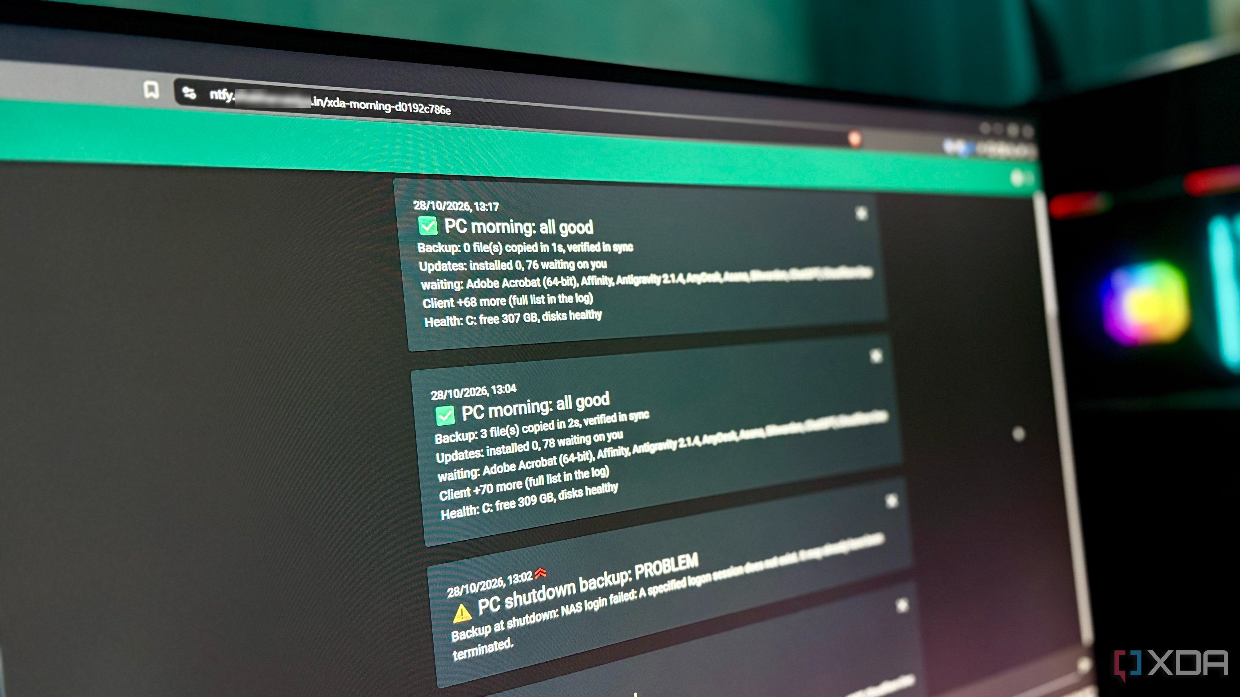 Monitor showing ntfy notifications with two all-good morning digests above a shutdown backup problem alert