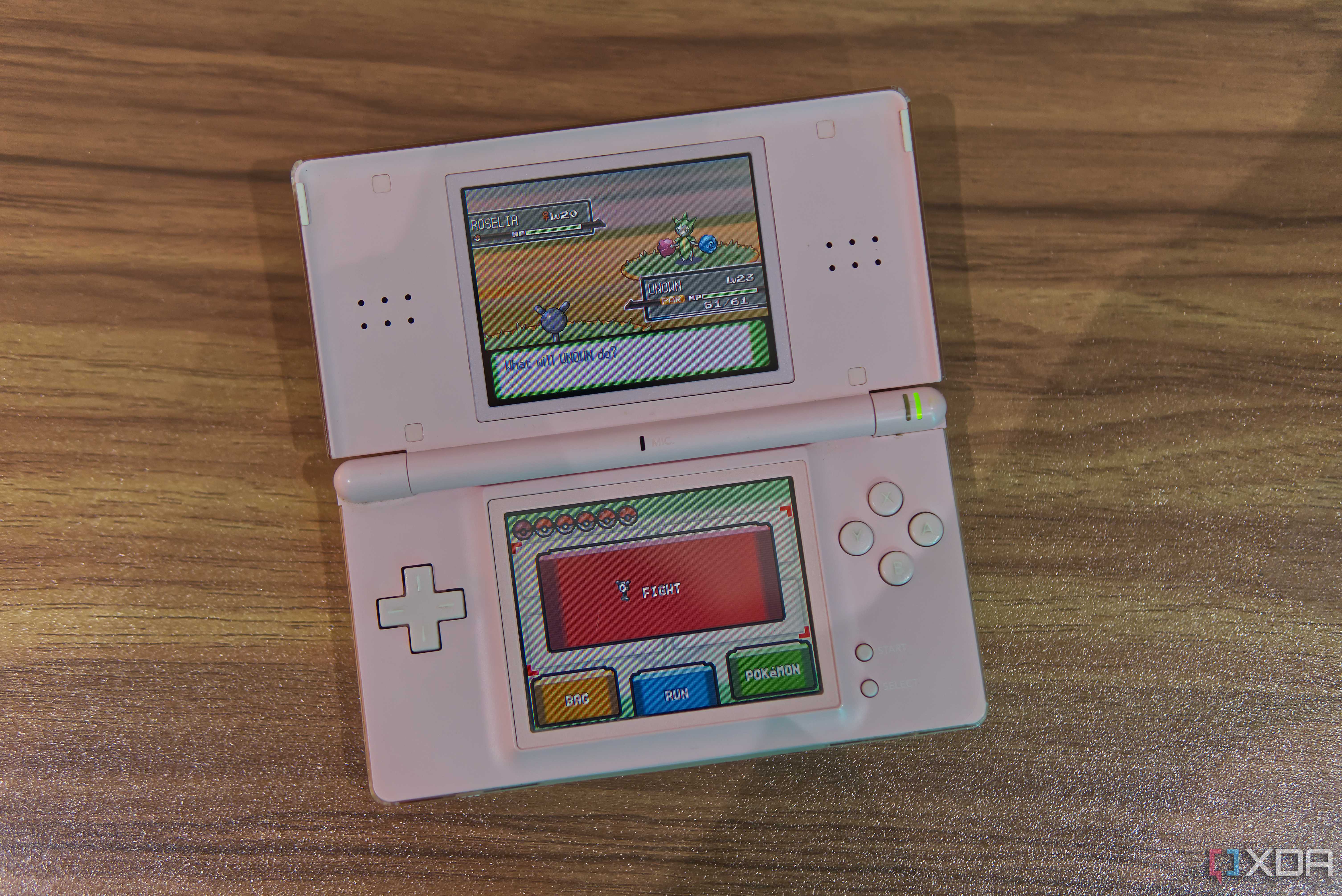 A Nintendo DS Lite showing a Pokémon Platinum battle