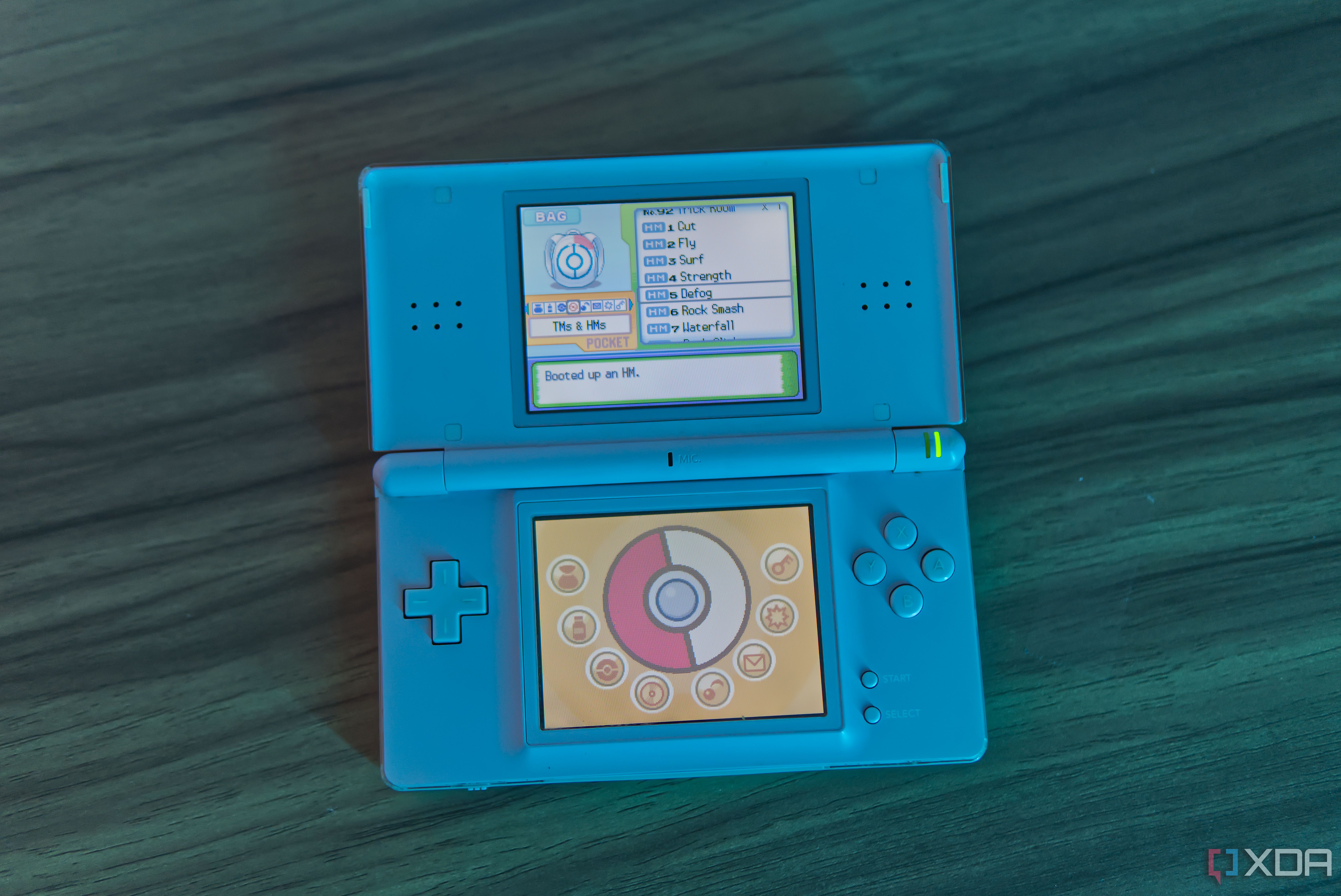 A Nintendo DS Lite showing the bag menu and a dialog for teaching a move using an HM